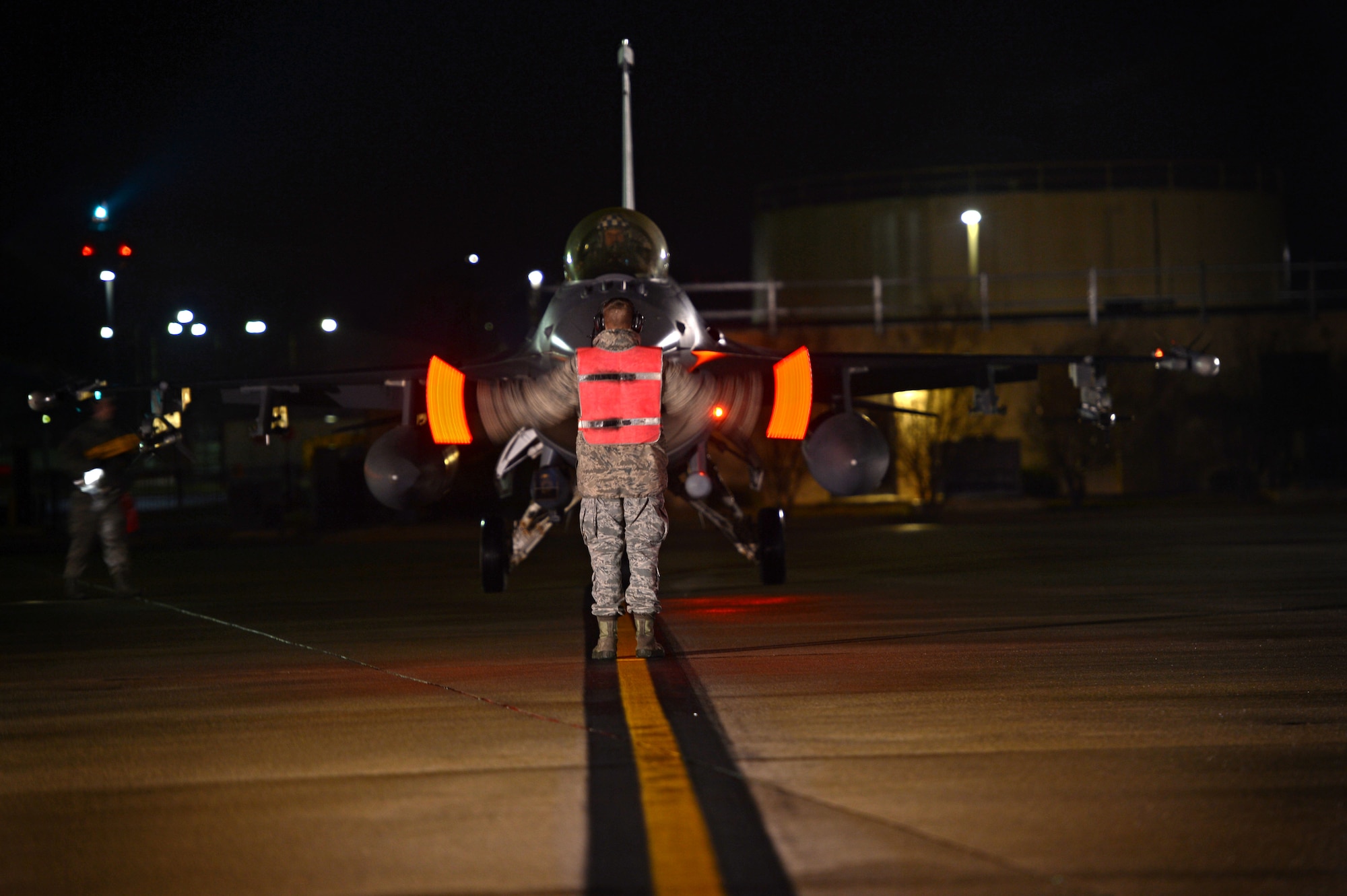 A U.S. Air Force tactical aircraft maintainer assigned to the 20th Aircraft Maintenance Squadron, marshals an F-16CM Fighting Falcon during hot pit refueling at Shaw Air Force Base, S.C., Jan. 15, 2015. Tactical aircraft maintainers are trusted with the maintenance and care of the aircraft they are assigned to. (U.S. Air Force photo by Senior Airman Jensen Stidham/Released) 