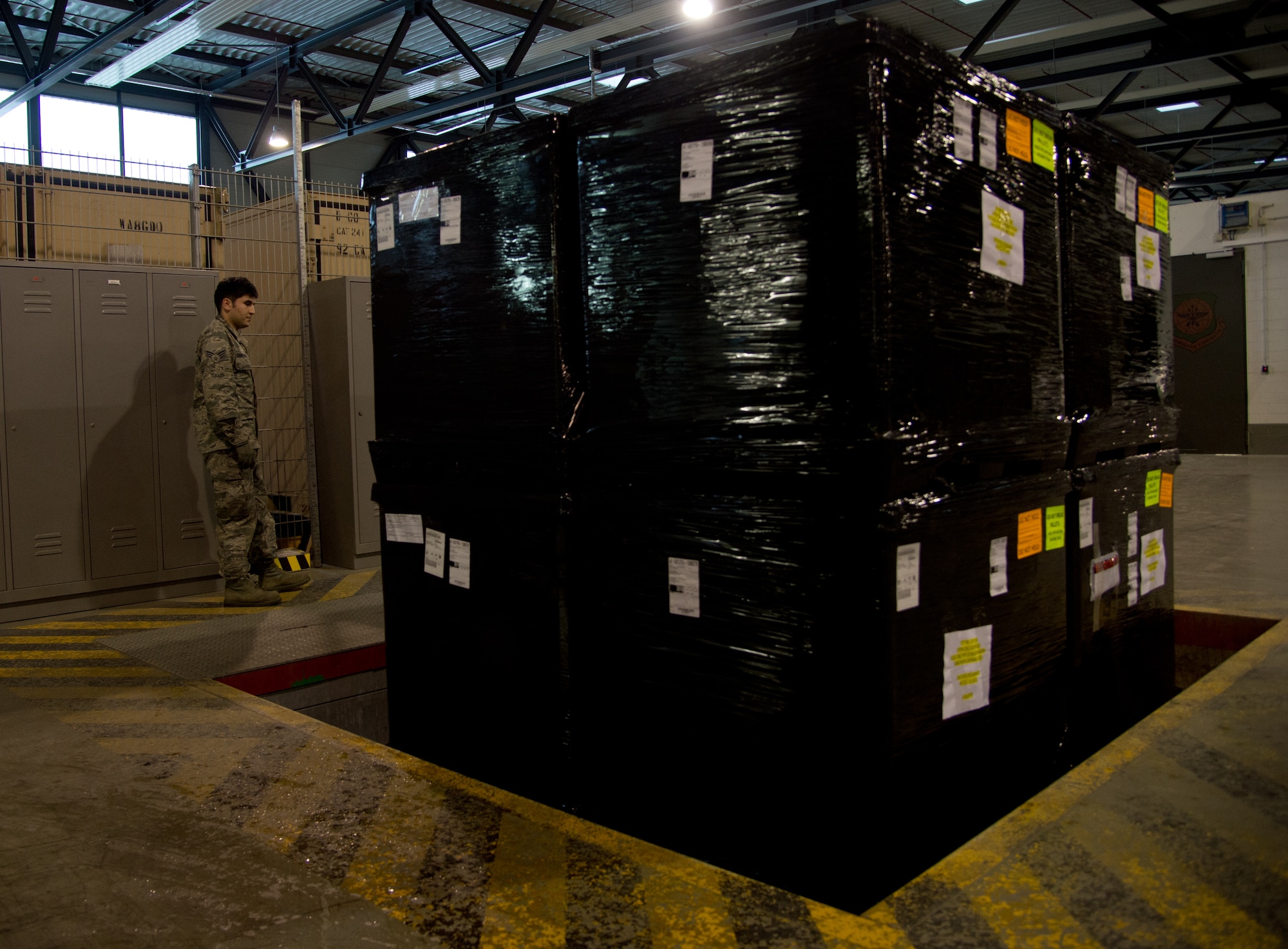 Senior Airman Eddy Santibanez, 721st Aerial Port Squadron, prepares to break down a bundle for storage, at Ramstein Air Base, Germany, Jan. 16, 2015. The 721st APS Airmen undergo specific training to be qualified to supervise and handle hazardous material, human remains, refrigerated materials, registered mail and ice or re-ice sensitive cargo. (U.S. Air Force photo/Senior Airman Jonathan Stefanko)
