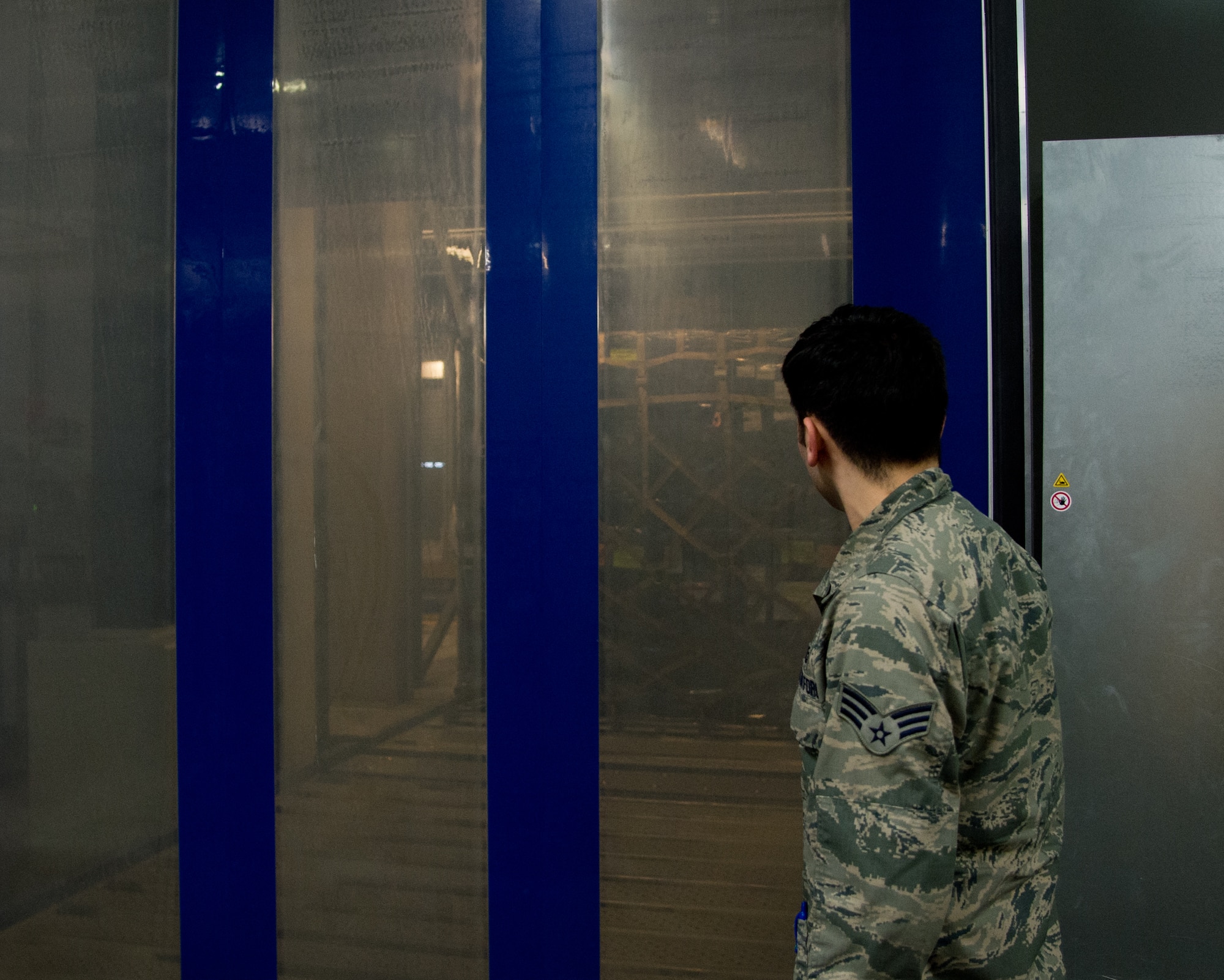 Senior Airman Eddy Santibanez, 721st Aerial Port Squadron special handler, removes sensitive cargo from storage, at Ramstein Air Base, Germany, Jan. 16, 2015. Along with handling hazardous and refrigerated material, they handle the transfer of fallen service members from down range to Dover Air Force Base, Delaware. (U.S. Air Force photo/ Senior Airman Jonathan Stefanko)