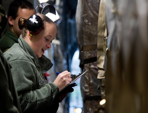 Airman 1st Class Stephanie Gilmartin, 721st Aerial Port Squadron special handler, checks to ensure she is receiving the correct cargo, at Ramstein Air Base, Germany, Jan. 16, 2015. The 721st APS special handlers are a select group who are trained and certified to handle hazardous material, human remains, refrigerated materials, registered mail and ice or re-ice sensitive cargo. (U.S. Air Force photo/ Senior Airman Jonathan Stefanko)