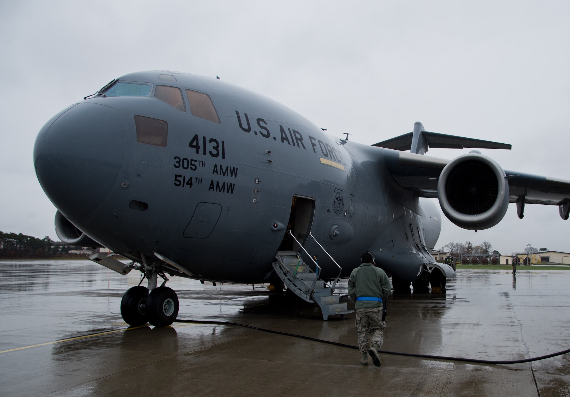 Senior Airman Eddy Santibanez, 721st Aerial Port Squadron special handler, walks toward a C-17 Globemaster III to sign for cargo before unloading, at Ramstein Air Base, Germany, Jan. 16, 2015. The 721st APS Airmen are required to supervise hazardous material. human remains, refrigerated materials, registered mail and ice or re-ice sensitive cargo until stored safely in their compound. (U.S. Air Force photo/Senior Airman Jonathan Stefanko)