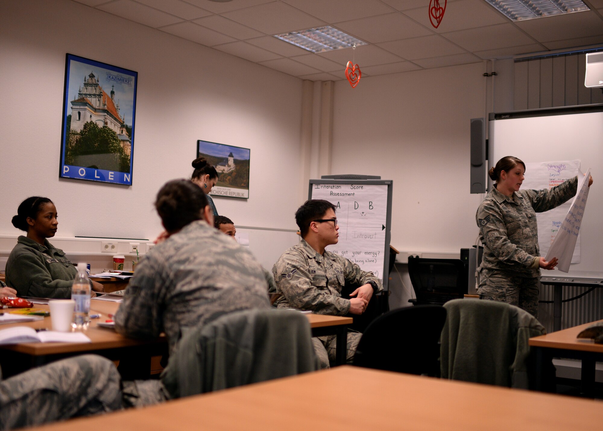 An Airman delivers a presentation during the Four Lenses assessment Jan. 14, 2015, in the 52nd Force Support Squadron's Airman and Family Readiness Center at Spangdahlem Air Base, Germany. The instructors separated the class into groups who then created a list of values, strengths, needs and joys of their personality types. (U.S. Air Force photo by Staff Sgt. Daryl Knee/Released)