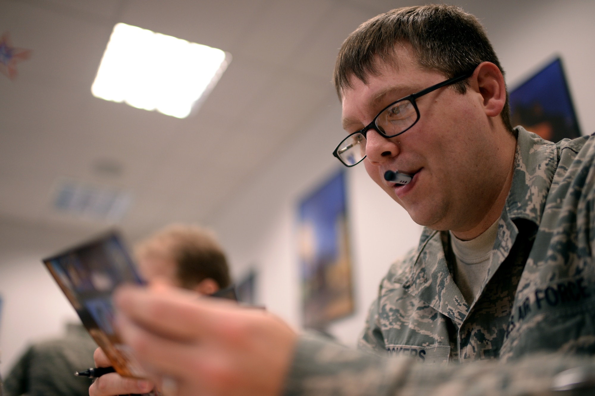 An Airman participates in a Four Lenses personality assessment Jan. 14, 2015, in the 52nd Force Support Squadron's Airman and Family Readiness Center at Spangdahlem Air Base, Germany. During this assessment, the participants had to review different photographs and phrases that best describe their personality. Then, the participants were separated into four colors — blue for people who value relationships; green for competency; orange for freedom; and gold structure. (U.S. Air Force photo by Staff Sgt. Daryl Knee/Released)
