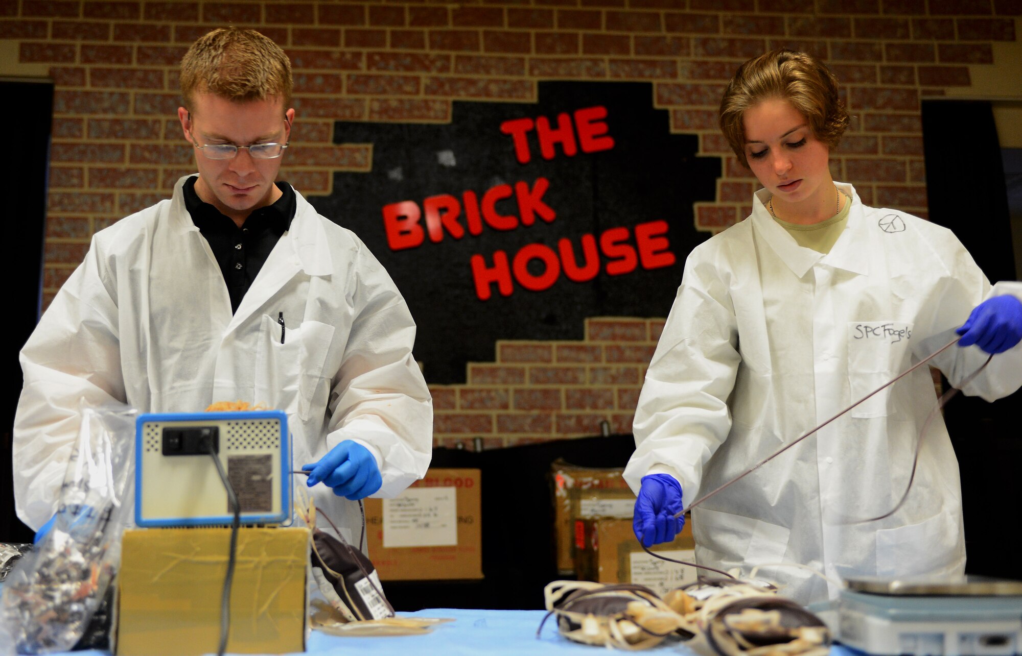 Two Landstuhl Regional Medical Center laboratory technicians prepare bags of blood to be transported during the Armed Services Blood Program blood drive at the Brick House in the community center at Spangdahlem Air Base, Germany, Jan. 20, 2015. The ASBP was established more than 60 years ago as a joint field operating agency. (U.S. Air Force photo by Airman 1st Class Luke Kitterman/Released)
