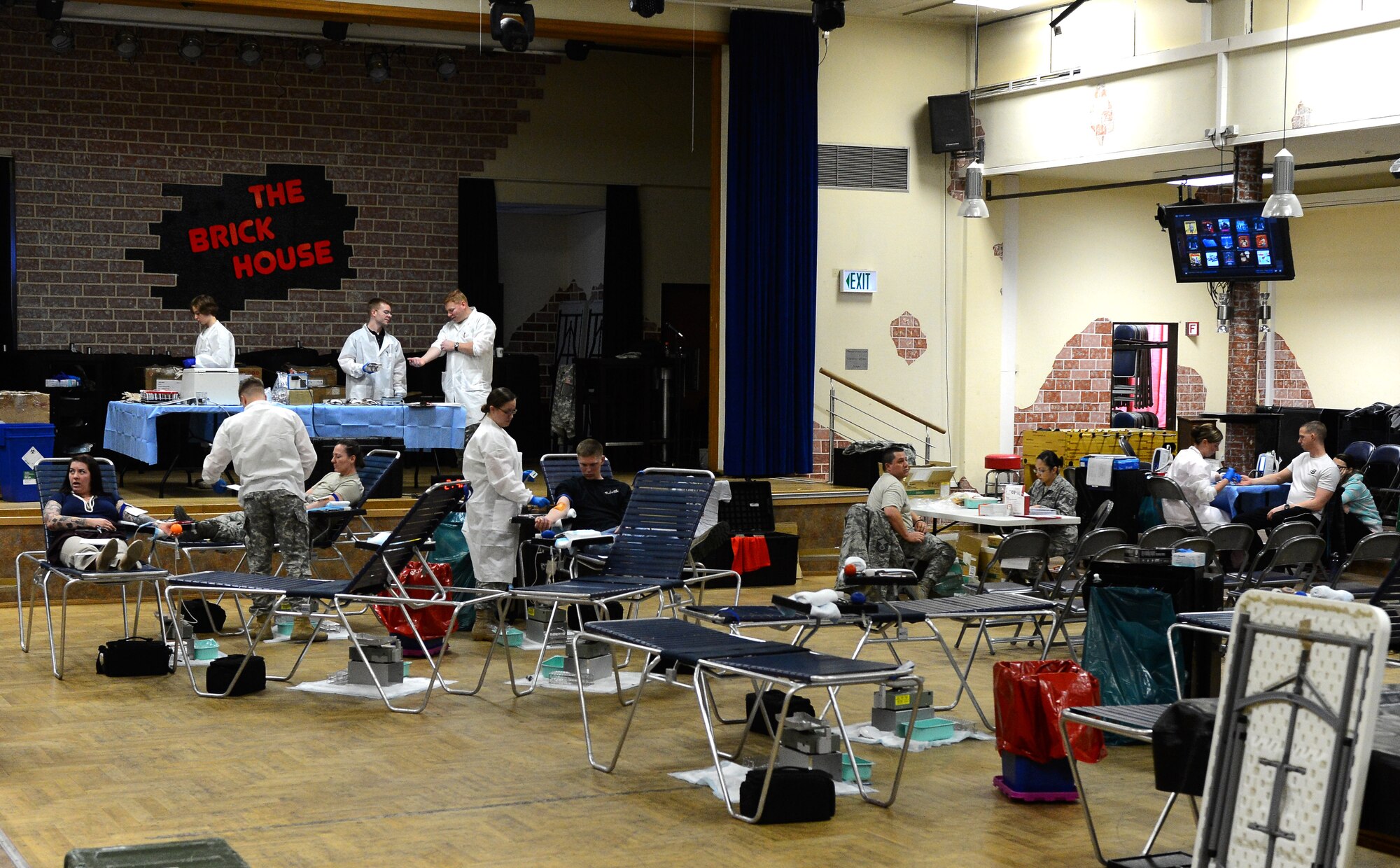 Blood donors and Landstuhl Regional Medical Center laboratory technicians gather during an Armed Services Blood Program blood drive at the Brick House in the community center on Spangdahlem Air Base, Germany, Jan. 20, 2015. The ASBP travels to Spangdahlem approximately once every two months and facilitates more than 50 donors each visit. (U.S. Air Force photo by Airman 1st Class Luke Kitterman/Released)