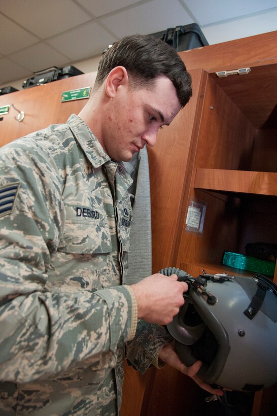 Staff Sgt. Billy Debord, 51st Operations Support Squadron aircrew flight equipment craftsman, inspects a pilots helmet at Osan Air Base, Republic of Korea, Jan. 16, 2015. The aircrew's flight equipment is inspected three hours before the first flight to ensure the equipment is in working condition. (U.S. Air Force photo by Senior Airman Matthew Lancaster)