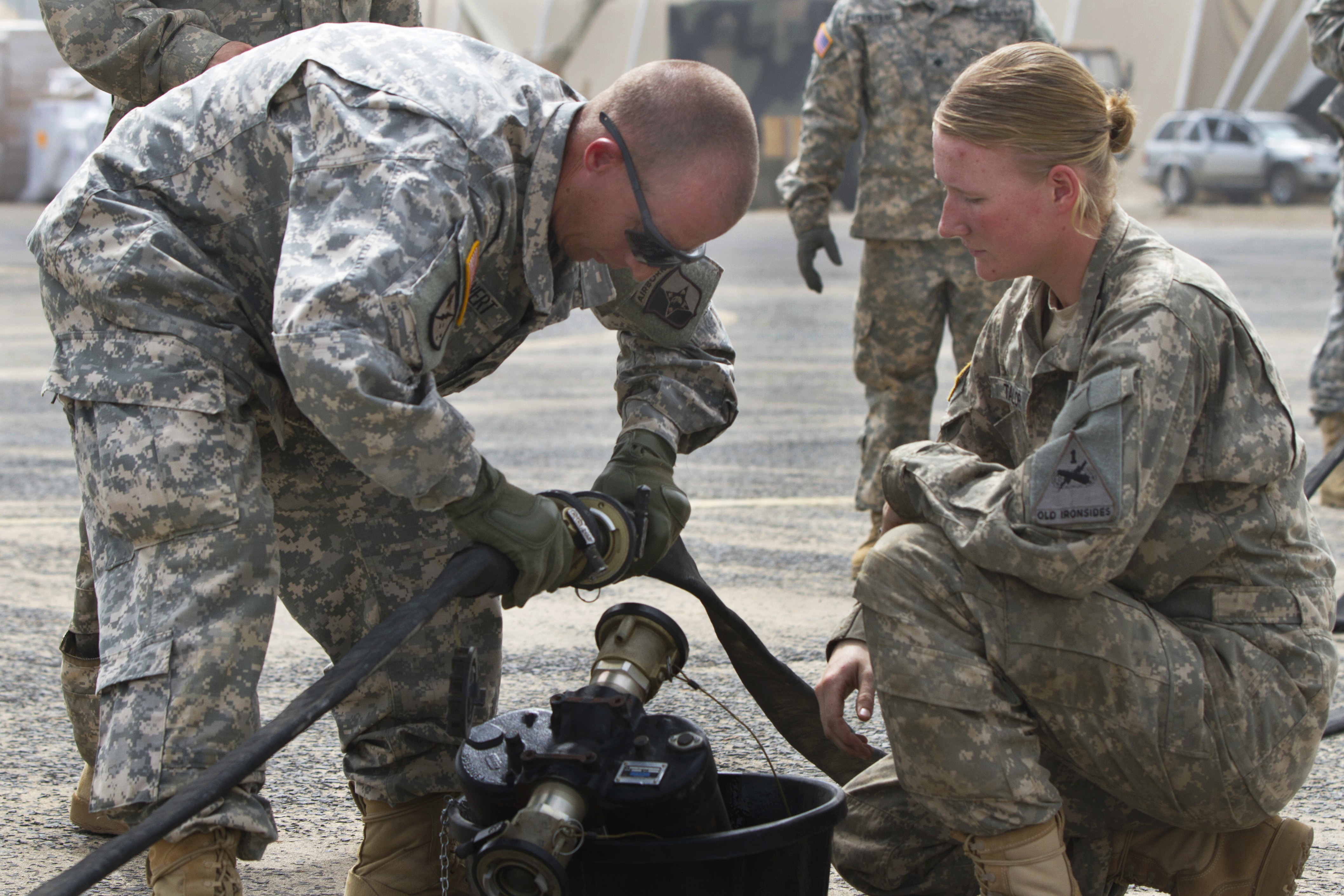 U.S. Army Spc. Danielle Taylor, right, teaches U.S. Army Sgt. Jarred