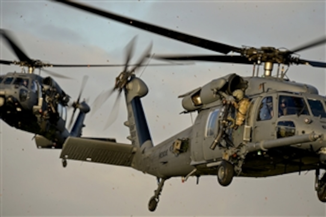 Two HH-60G Pave Hawk helicopters respond in a combat scenario for search and rescue on the Royal Air Force Lakenheath facility in the United Kingdom, Jan. 16, 2015. The helicopters are assigned to the 56th Rescue Squadron.