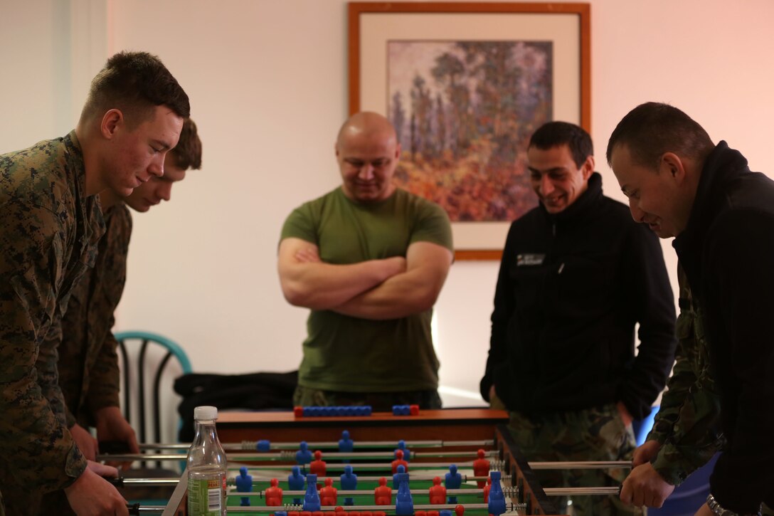 Black Sea Rotational Force Marines and Bulgarian soldiers play a friendly game of foosball against each other during a break in their classes on Jan. 13. The Marines are currently on exercise Platinum Lion 15 at Novo Selo Training Area, Bulgaria, working with Bulgarian, Serbian and Romanian armed forces. (U.S. Marine Corps photo by Cpl. Ryan Young/ released)