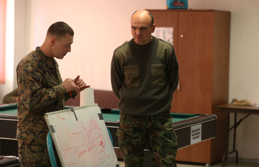 A Bulgarian translator listens attentively to a Black Sea Rotational Force Marine as he teaches a class about mounted patrolling Jan. 13 at Novo Selo Training Area, Bulgaria. BSRF Marines and Bulgarian soldiers are training together on Platinum Lion 15, a multi-national training exercise. (U.S. Marine Corps photo by Cpl. Ryan Young/released)