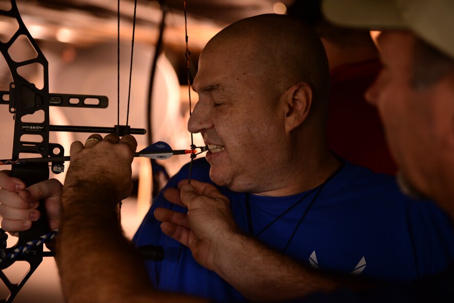 Tech. Sgt. (ret.) Matt Slaydon readies his bow and arrow during the archery event for the Air Force Wounded Warrior Adaptive Sports and Reconditioning Camp at Joint Base San Antonio-Randolph, Texas, Jan 21, 2015. Slaydon, an Explosive Ordnance Disposal technician, was wounded by an improvised explosive device in Iraq in 2007 resulting in the loss of his left arm and his eye sight. (U.S. Air Force photo by Tech. Sgt. Joshua Strang)
