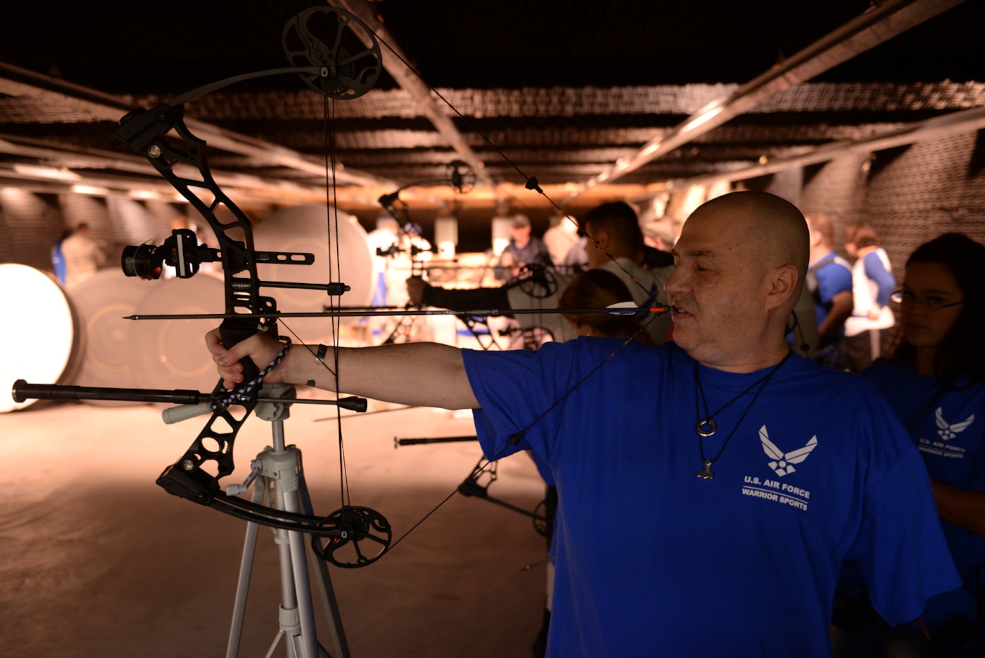 Tech. Sgt. (ret.) Matt Slaydon readies his bow and arrow during the archery event for the Air Force Wounded Warrior Adaptive Sports and Reconditioning Camp at Joint Base San Antonio-Randolph, Texas, Jan 21, 2015. Slaydon, an Explosive Ordnance Disposal technician, was wounded by an improvised explosive device in Iraq in 2007 resulting in the loss of his left arm and his eye sight.. (U.S. Air Force photo by Tech. Sgt. Joshua Strang)