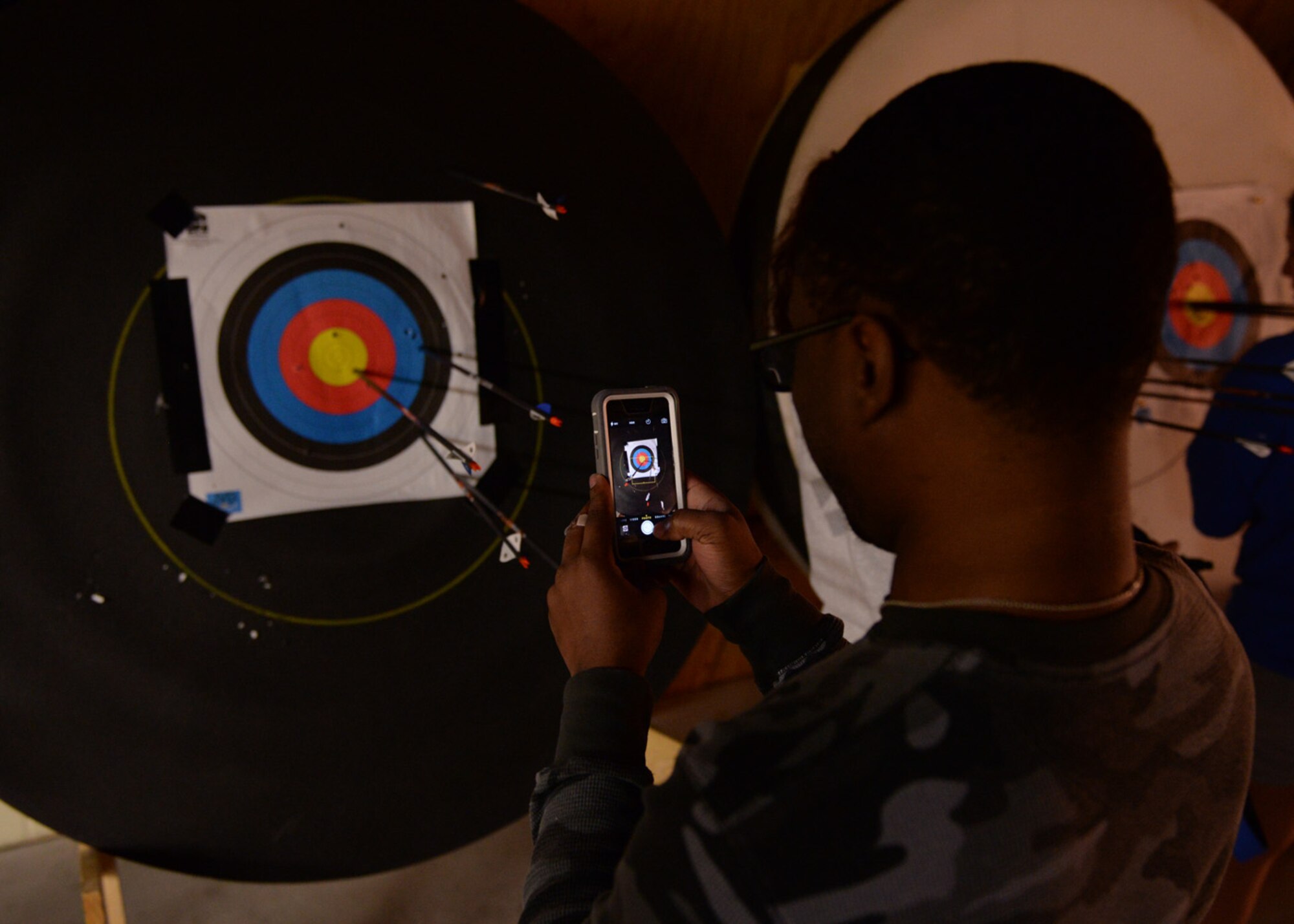 Senior Airman Ryan Cureton takes a photo of his arrow placement during the archery event for the Air Force Wounded Warrior Adaptive Sports and Reconditioning Camp at Joint Base San Antonio-Randolph, Texas, Jan 21, 2015. Cureton suffered a traumatic brain injury after an auto accident and has suffered from limited vision since. (U.S. Air Force photo by Tech. Sgt. Joshua Strang)