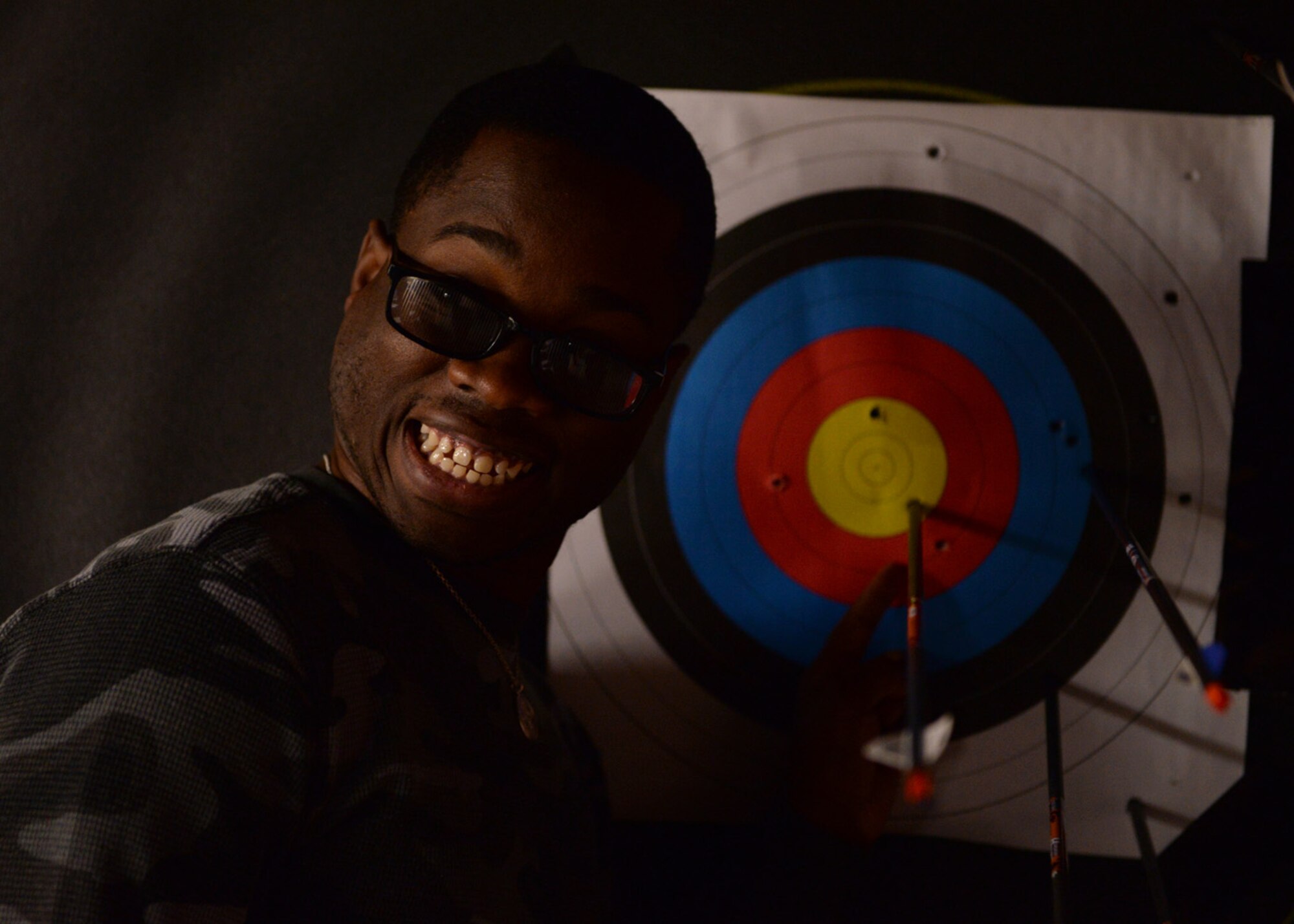 Senior Airman Ryan Cureton poses for a photo with his arrow during the archery event for the Air Force Wounded Warrior Adaptive Sports and Reconditioning Camp at Joint Base San Antonio-Randolph, Texas, Jan 21, 2015. Cureton suffered a traumatic brain injury after an auto accident and has suffered from limited vision since. (U.S. Air Force photo by Tech. Sgt. Joshua Strang)