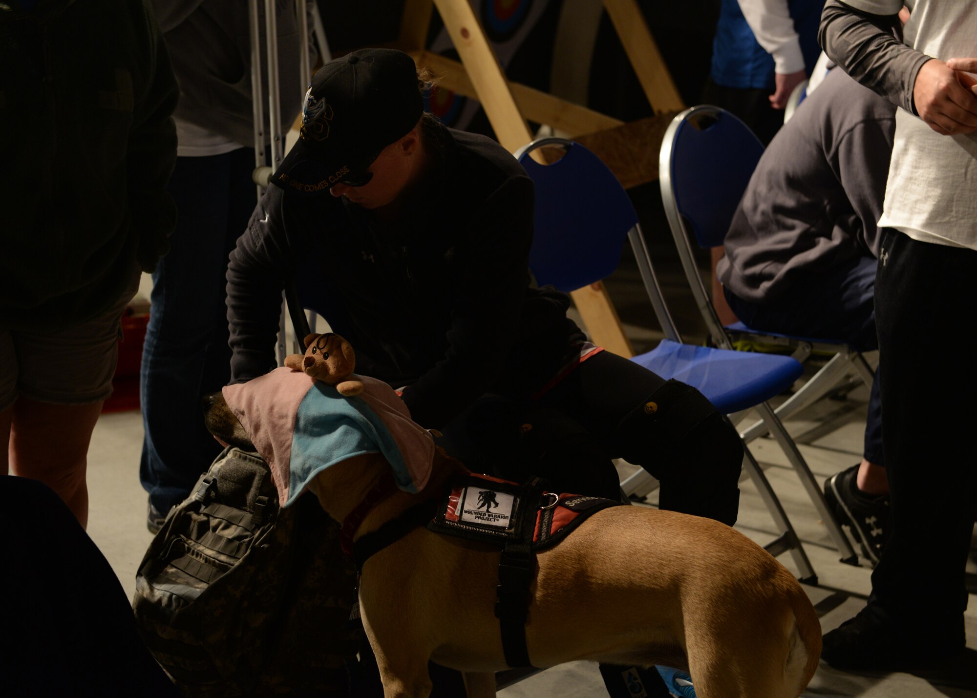 Air Force Senior Airman (ret.) Melissa Gonzalez takes a break with her service dog, Bindi, during the shooting event for the Air Force Wounded Warrior Adaptive Sports and Reconditioning Camp at Joint Base San Antonio-Randolph, Texas, Jan 21, 2015. Gonzalez suffered leg injuries and a traumatic brain injury due to an improvised explosive device in Afghanistan. (U.S. Air Force photo by Tech. Sgt. Joshua Strang)