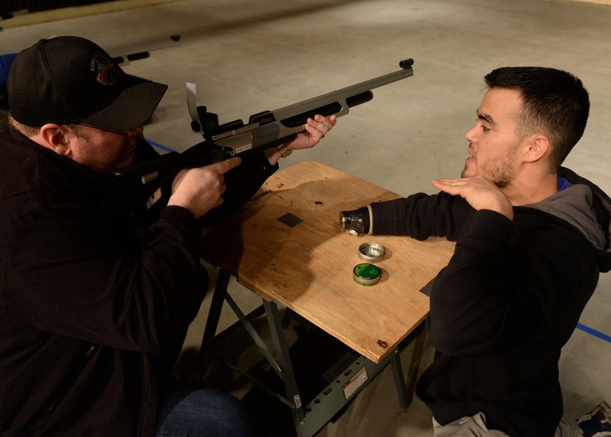 Air Force Staff Sgt. (ret.) Daniel Crane (right) instructs a wounded warrior on rifle technique during the shooting event for the Air Force Wounded Warrior Adaptive Sports and Reconditioning Camp at Joint Base San Antonio-Randolph, Texas, Jan 21, 2015. Crane has right arm paralysis after he suffered a wound while stationed in Guam. (U.S. Air Force photo by Tech. Sgt. Joshua Strang)