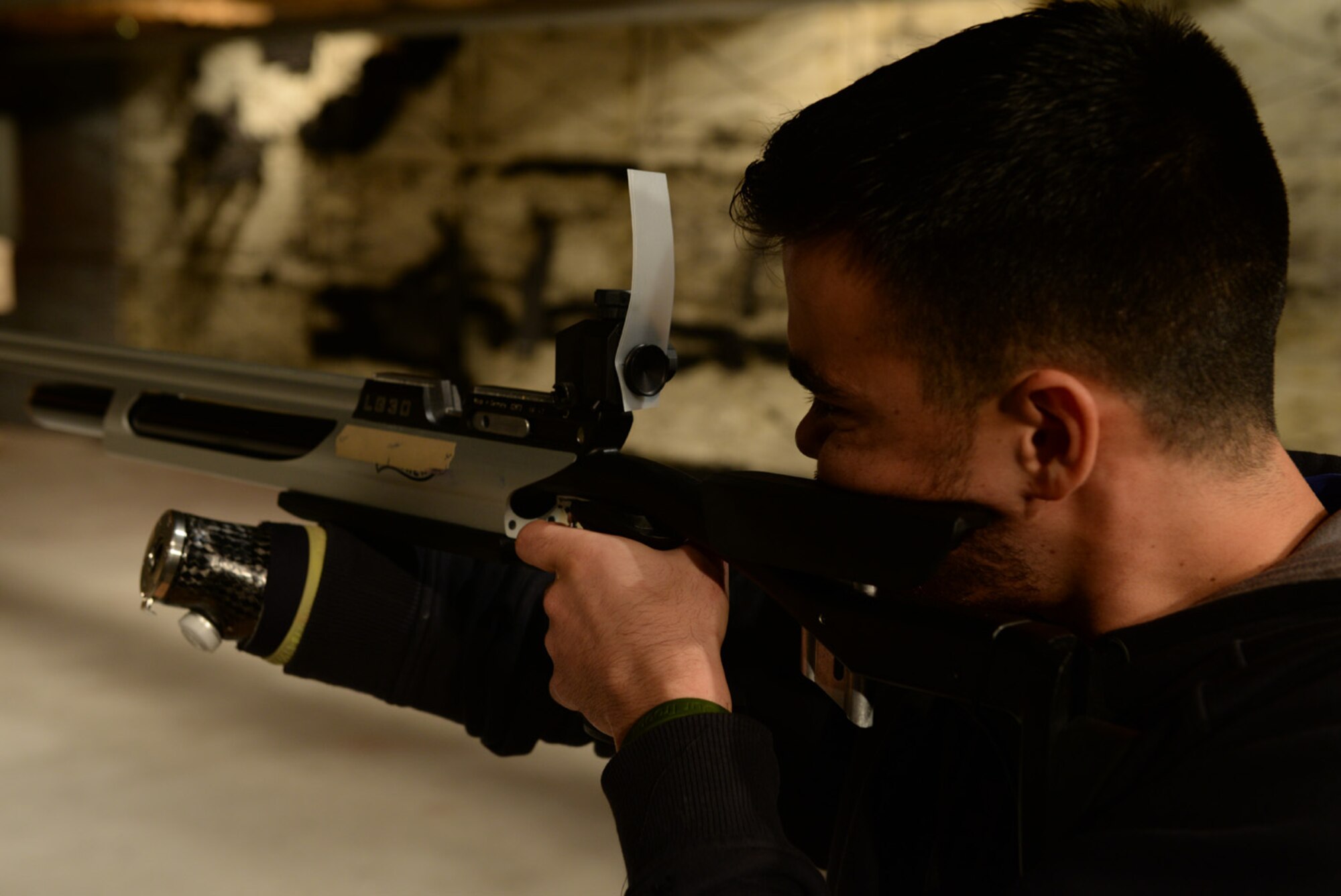 Air Force Staff Sgt. (ret.) Daniel Crane (right) shows proper rifle technique during the shooting event for the Air Force Wounded Warrior Adaptive Sports and Reconditioning Camp at Joint Base San Antonio-Randolph, Texas, Jan 21, 2015. Crane has right arm paralysis after he suffered a wound while stationed in Guam. (U.S. Air Force photo by Tech. Sgt. Joshua Strang)