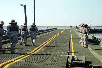 Louisiana National Guardsman Maj. James S. Slaven, executive officer of the 205th Engineer Battalion, inspects a 300-foot improved ribbon bridge built by the 2225th Multi-Role Bridge Company, out of Marrero, La., at the Frank Campo Marina in Shell Beach, La., May 6. The 2225th constructed the bridge to serve as a temporary wharf for oil spill boom distribution in St. Bernard Parish.