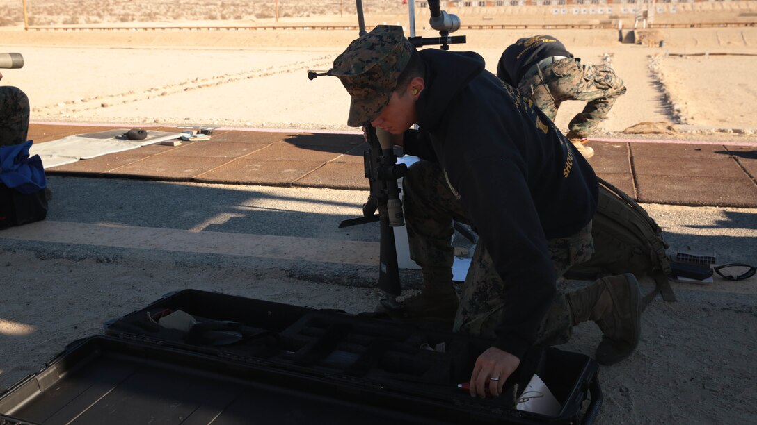Lance Cpl. Brandon Debolt, 1st Tank Battalion, native of Philadelphia, Pa., puts his weapon away in preparation to move to the next yard line during the Combat Center DieSeL Classic at the base Qualification Range, Jan. 17, 2015. 
