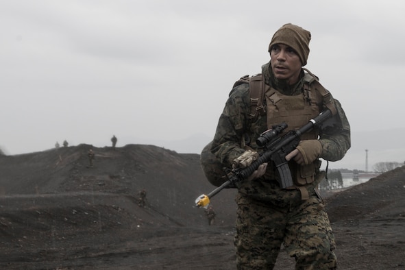A Marine with the 1st Batallion, 1st Marines, scouts for aircrew during joint training Jan. 16, 2015 at Camp Fuji, Japan. Marines and Sailors acted as enemy aggressors, practicing their patrolling techniques, while searching for Air Force aircrew, who were simultaneously training their survival, evasion, resistance and escape techniques. (U.S. Air Force photo/Staff Sgt. Cody H. Ramirez)