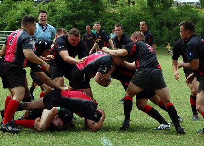 1st Lt. David Bryant (light blue shirt in background), a member of the Indiana National Guard, was chosen as a referee for the USA Rugby Military Club Championship at Fort Benning, Ga. In this game, the Marine team from Camp Lejeune N.C., fights to gain another inch on the rugby field as Soldiers from Fort Hood, Texas try to push them back during the consolation finals for the April 30, 2010. The Marines won 15-12 against Fort Hood.