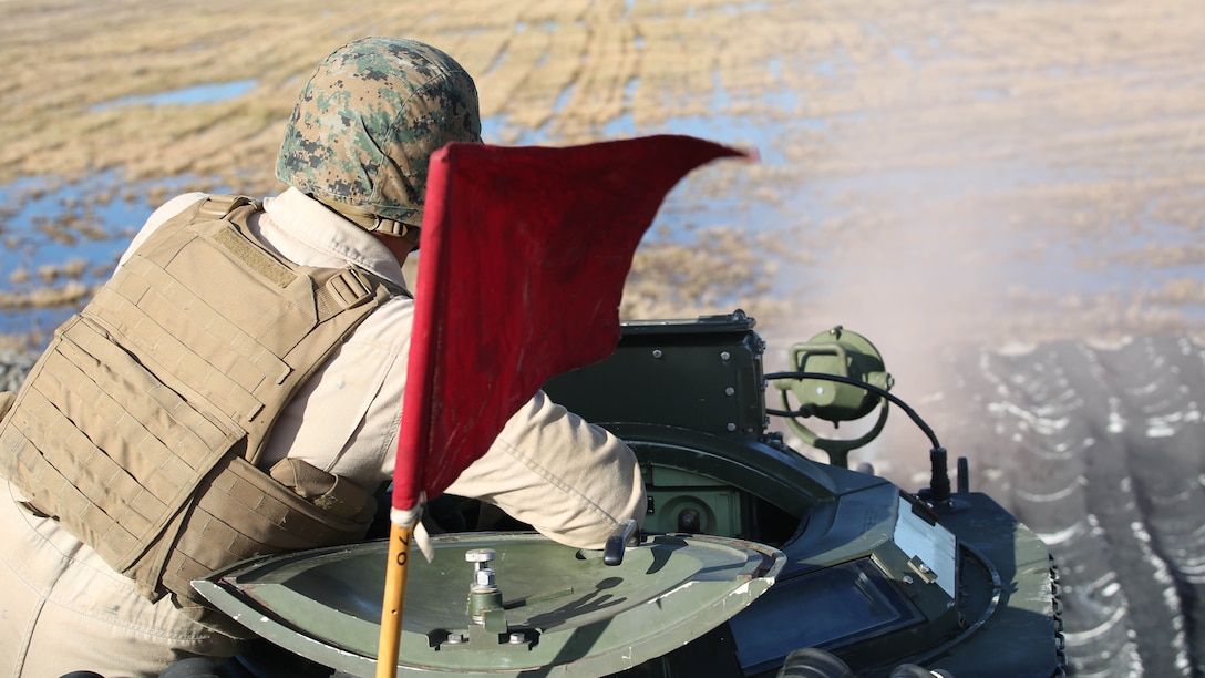 Staff Sgt. Charles L. Burger, section leader, Amphibious Assault Vehicle Platoon, Company B, Ground Combat Element Integrated Task Force, observes rounds fired downrange during a live-fire exercise at Range SR-10 aboard Marine Corps Base Camp Lejeune, North Carolina, Jan. 20, 2015. From October 2014 to July 2015, the GCEITF will conduct individual and collective level skills training in designated ground combat arms occupational specialties in order to facilitate the standards based assessment of the physical performance of Marines in a simulated operating environment performing specific ground combat arms tasks. 