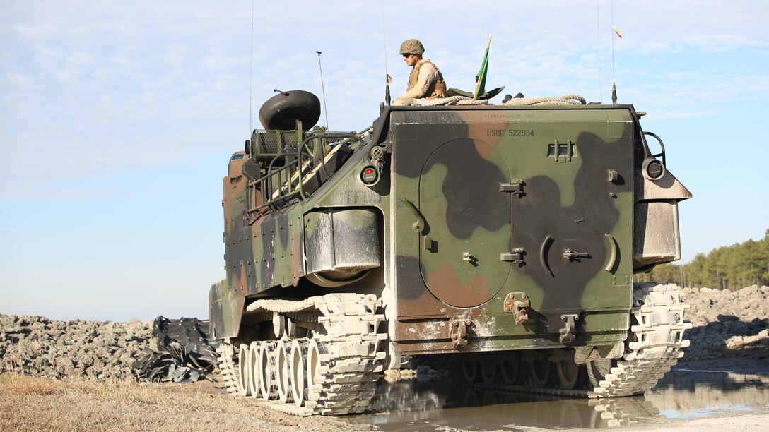 Staff Sgt. Charles L. Burger, section leader, Amphibious Assault Vehicle Platoon, Company B, Ground Combat Element Integrated Task Force, sits atop an AAV during a live-fire exercise at Range SR-10 aboard Marine Corps Base Camp Lejeune, North Carolina, Jan. 20, 2015. From October 2014 to July 2015, the GCEITF will conduct individual and collective level skills training in designated ground combat arms occupational specialties in order to facilitate the standards based assessment of the physical performance of Marines in a simulated operating environment performing specific ground combat arms tasks. 