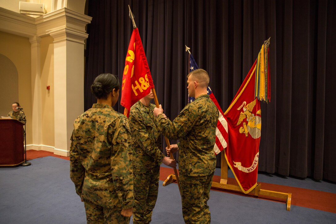 Capt. Brian Lander, outgoing Headquarters and Service Company commander, relinquishes command to Capt. John Ed Auer at Marine Barracks Washington, D.C. Jan. 21, 2015. (U.S. Marine Corps Photo by Lance Cpl. Christian Varney/Released)