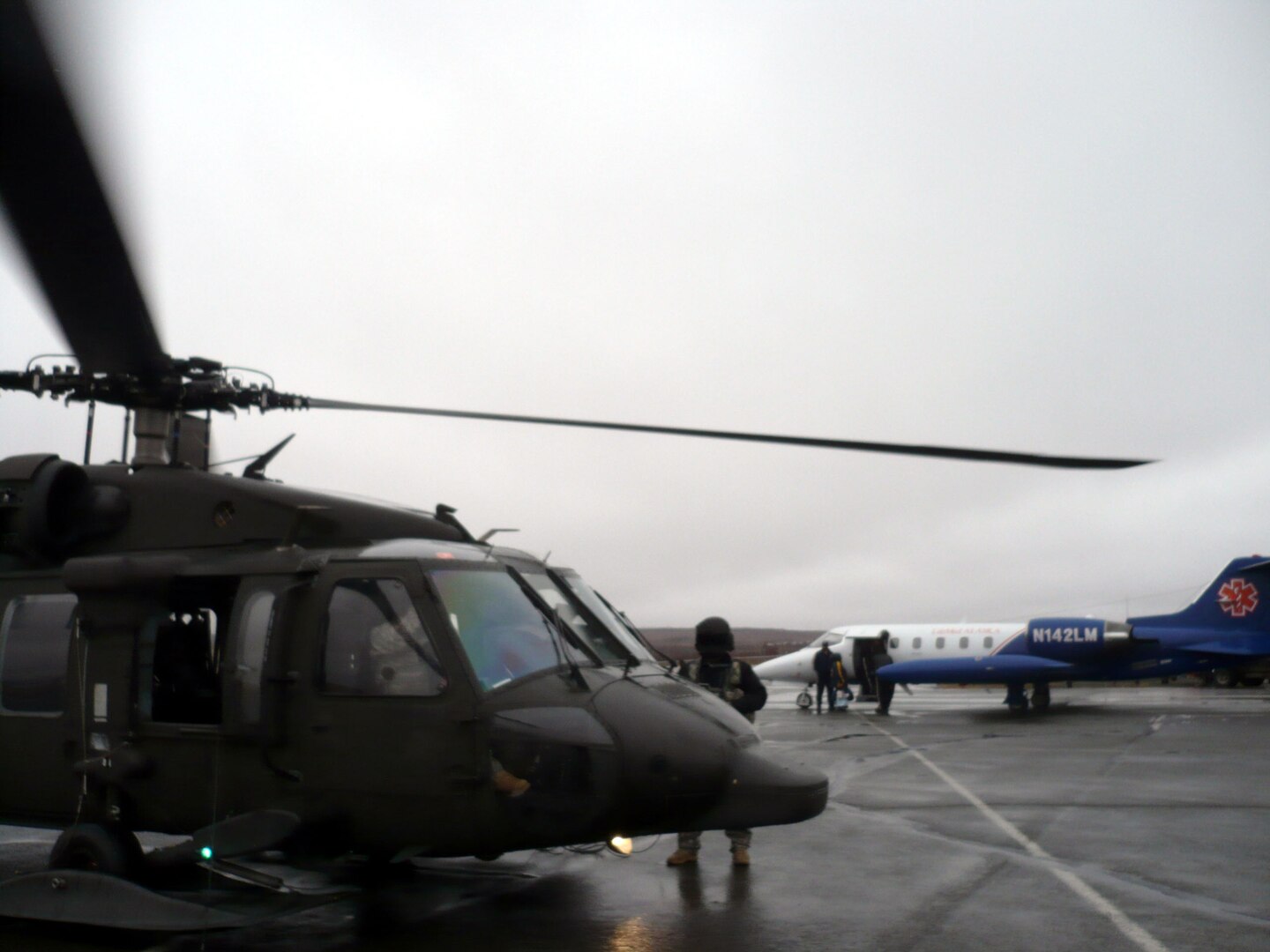 A three-month-old child suffering respiratory failure and mother are transported from an Alaska Army National Guard UH-60 Black Hawk to a LifeMed Alaska aircraft May 8 at the Bethel airport. Guardsmen transported the infant from the Hooper Bay clinic to Bethel with two flight medics from LifeMed Alaska onboard
