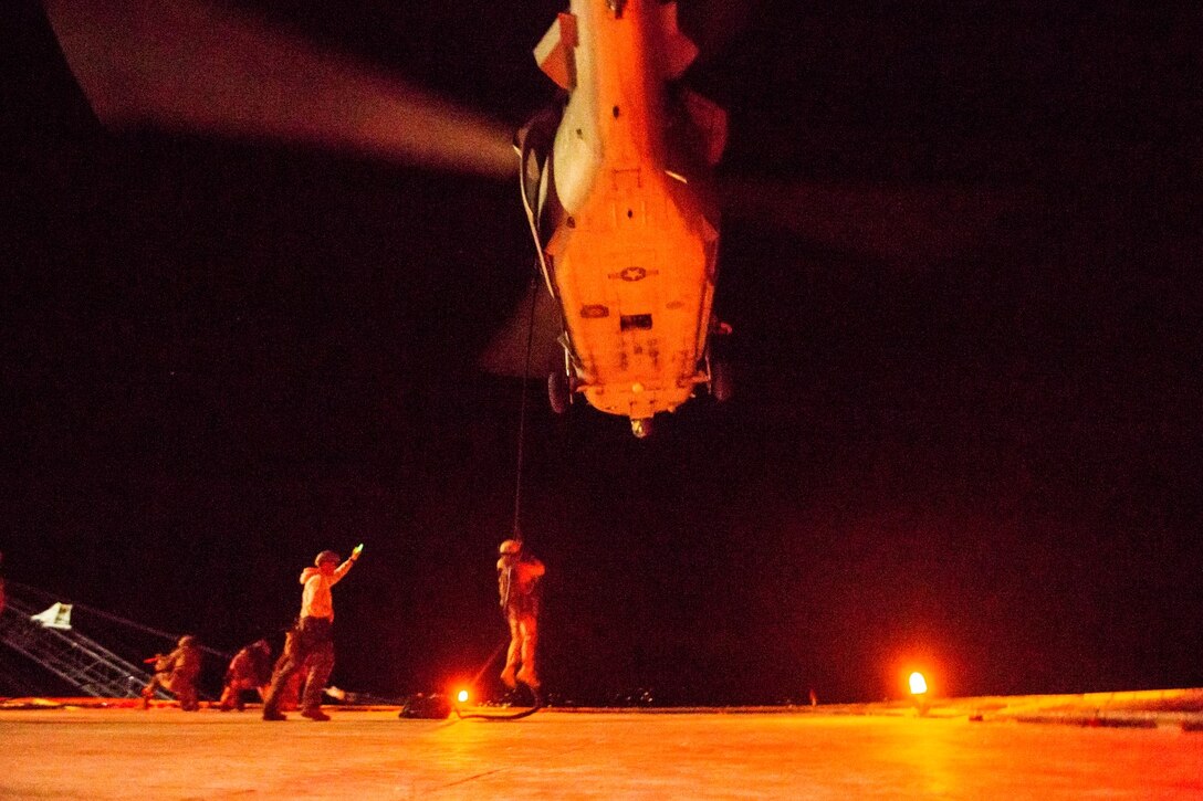 U.S. Marines with the 15th Marine Expeditionary Unit's Maritime Raid Force fast-rope from an MH-60R during maritime interoperability training off the coast of Santa Barbara, Calif., Jan. 16, 2015. MIT prepares the MRF for their upcoming deployment by enhancing their combat skills, and teaching them techniques for boarding vessels. (U.S. Marine Corps photo by Sgt. Jamean Berry/Released)