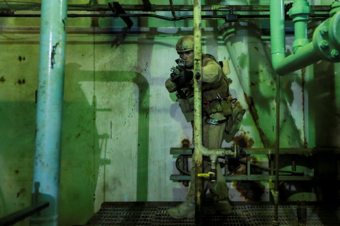 A U.S. Marine with the 15th Marine Expeditionary Unit's Maritime Raid Force clears potential danger areas during maritime interoperability training off the coast of Santa Barbara, Calif., Jan. 16, 2015. MIT prepares the MRF for their upcoming deployment by enhancing their combat skills, and teaching them techniques for boarding vessels. (U.S. Marine Corps photo by Sgt. Jamean Berry/Released)