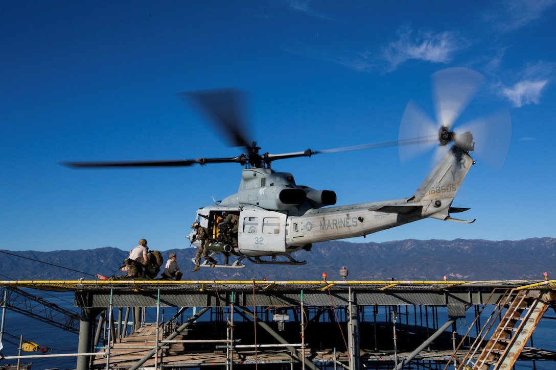 U.S. Marines with the 15th Marine Expeditionary Unit's Maritime Raid Force step off from a UH-1Y Venom onto a gas and oil platform during maritime interoperability training off the coast of Santa Barbara, Calif., Jan. 16, 2015. MIT prepares the MRF for their upcoming deployment by enhancing their combat skills and teaching them techniques for boarding vessels. (U.S. Marine Corps photo by Sgt. Jamean Berry/Released)