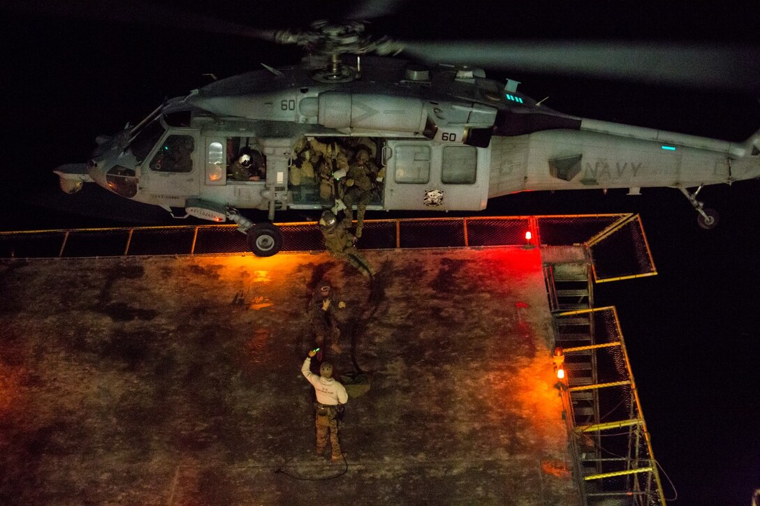 U.S. Marines with the 15th Marine Expeditionary Unit's Maritime Raid Force fast-rope onto a gas and oil platform during maritime interoperability training off the coast of Santa Barbara, Calif., Jan. 16, 2015. MIT prepares the MRF for their upcoming deployment by enhancing their combat skills and teaching them techniques for boarding vessels. (U.S. Marine Corps photo by Sgt. Jamean Berry/Released)