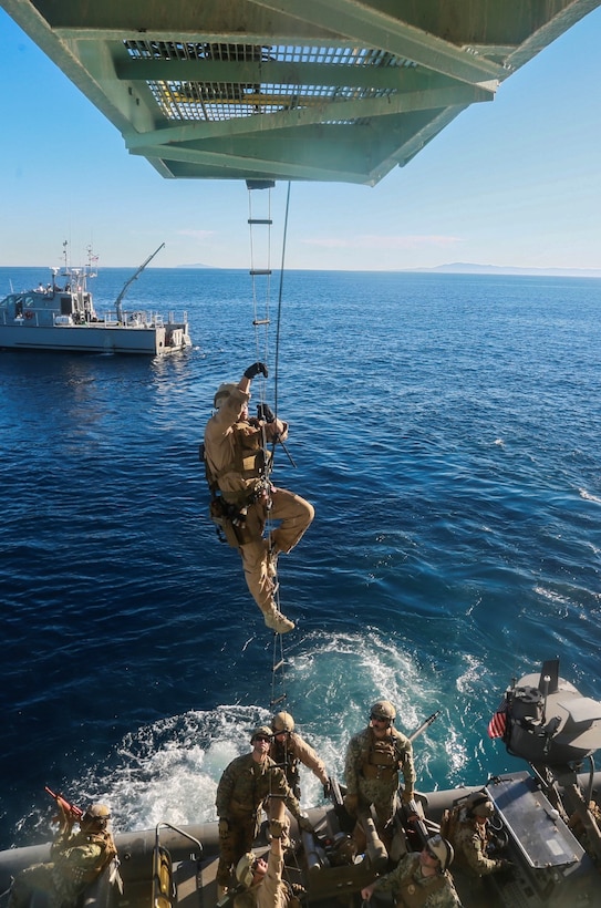 U.S. Marines with the 15th Marine Expeditionary Unit's Maritime Raid Force climbs a caving ladder to board a gas and oil platform during maritime interoperability training off the coast of Santa Barbara, Calif., Jan. 16, 2015. MIT prepares the MRF for their upcoming deployment by enhancing their combat skills, and teaching them techniques for boarding vessels. (U.S. Marine Corps photo by Sgt. Jamean Berry/Released)