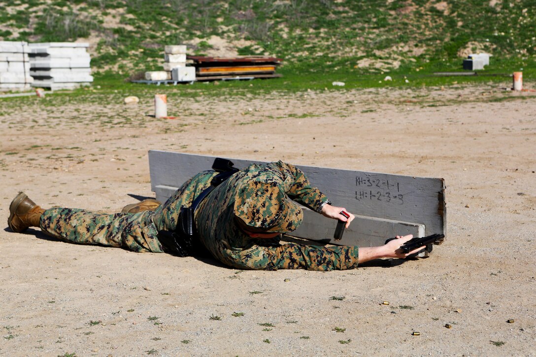 Staff Sgt. Glenn West, a chief accident investigator with Headquarters and Headquarters Squadron, reloads his M9 service pistol in the prone during a practical weapons course aboard Marine Corps Air Station Miramar, Calif., Jan. 21. The training is an annual requirement of all military police officers.