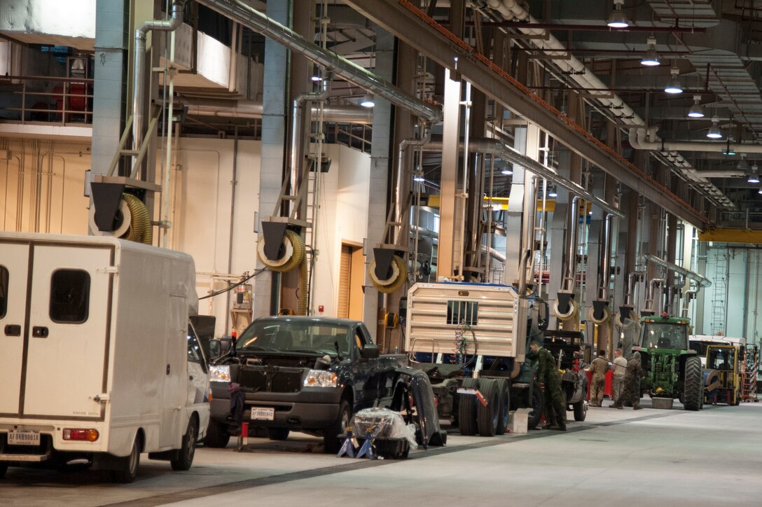 Airmen from the 51st Logistics Readiness Squadron Vehicle Maintenance shop repair government vehicles at Osan Air Base, Republic of Korea, Dec. 22, 2014. The main part of the shop consists the customer service section, the general purpose section, and the special purpose section. (U.S. Air Force photo by Senior Airman Matthew Lancaster)