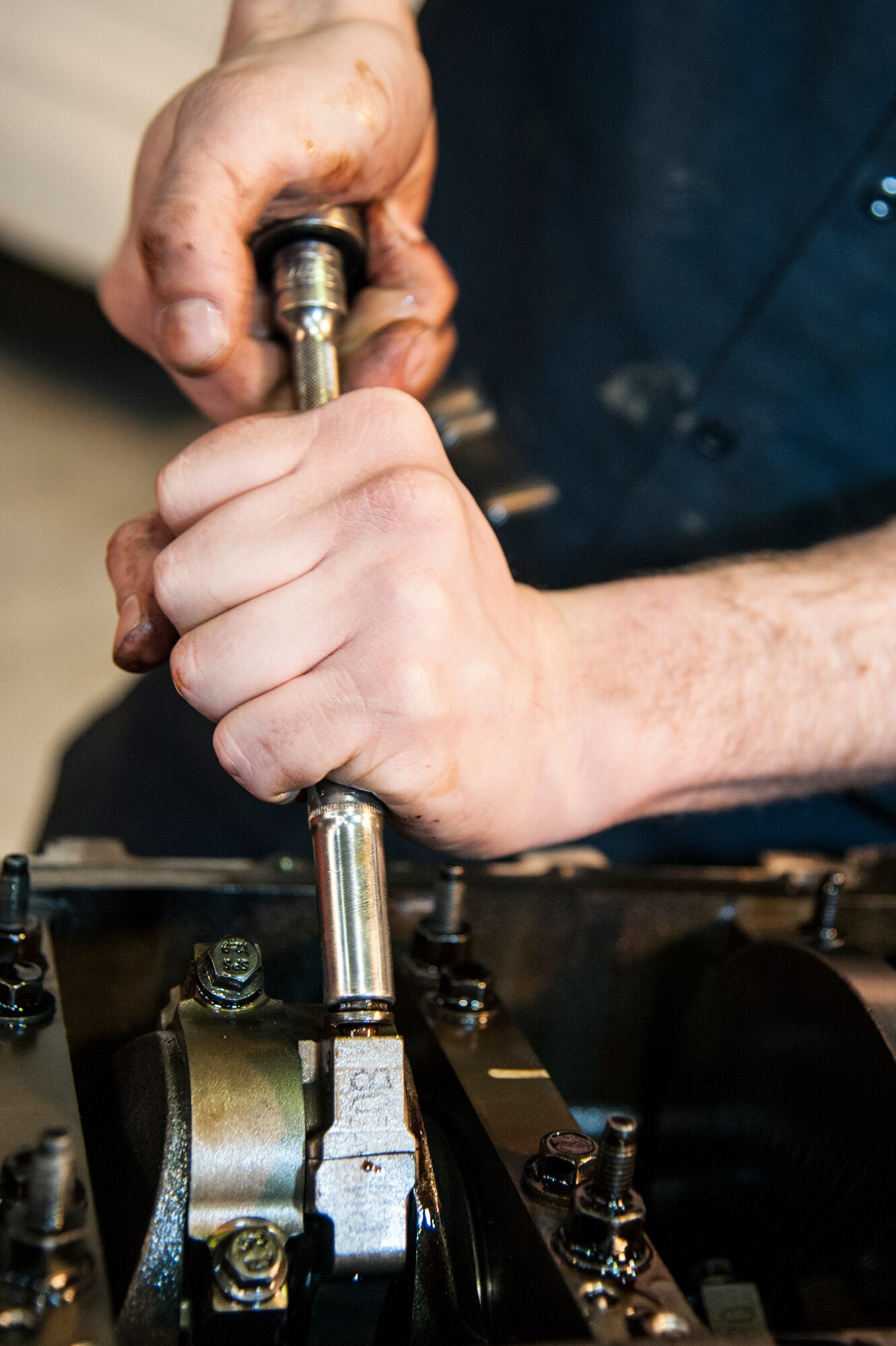 Senior Airman Joseph Hooker, 51st Logistics Readiness Squadron general purpose mechanic, reassembles a truck engine at Osan Air Base, Republic of Korea, Dec. 22, 2014. Hooker ensures each part of the engine is put back together properly before putting it back into the vehicle. (U.S. Air Force photo by Senior Airman Matthew Lancaster)
