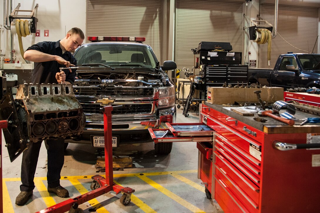 Senior Airman Joseph Hooker, 51st Logistics Readiness Squadron general purpose mechanic, reassembles a truck engine at Osan Air Base, Republic of Korea, Dec. 22, 2014. Hooker performs inspections and major repairs on general purpose vehicles such as security forces patrol cars. (U.S. Air Force photo by Senior Airman Matthew Lancaster)
