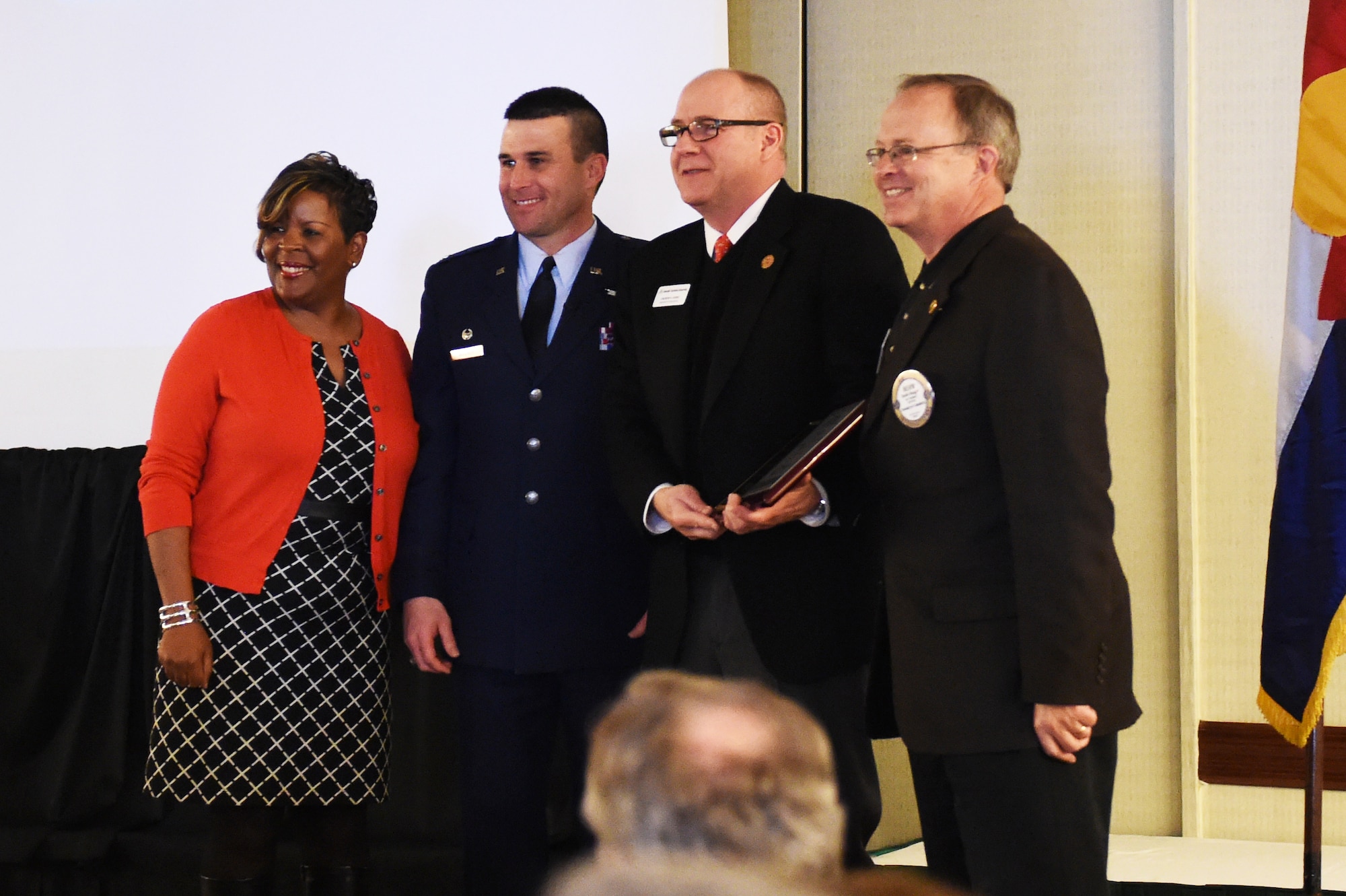 Col. John Wagner, 460th Space Wing commander, stands with community leaders at the State of the Base address Jan. 21, 2015, at the DoubleTree by Hilton in Aurora, Colo. During the speech, Wagner discussed the base’s mission and current and upcoming events for Team Buckley, along with the base’s economic impact on the community, Aurora Rotary and Aurora Chamber of Commerce. (U.S. Air Force photo by Airman 1st Class Samantha Saulsbury/Released)