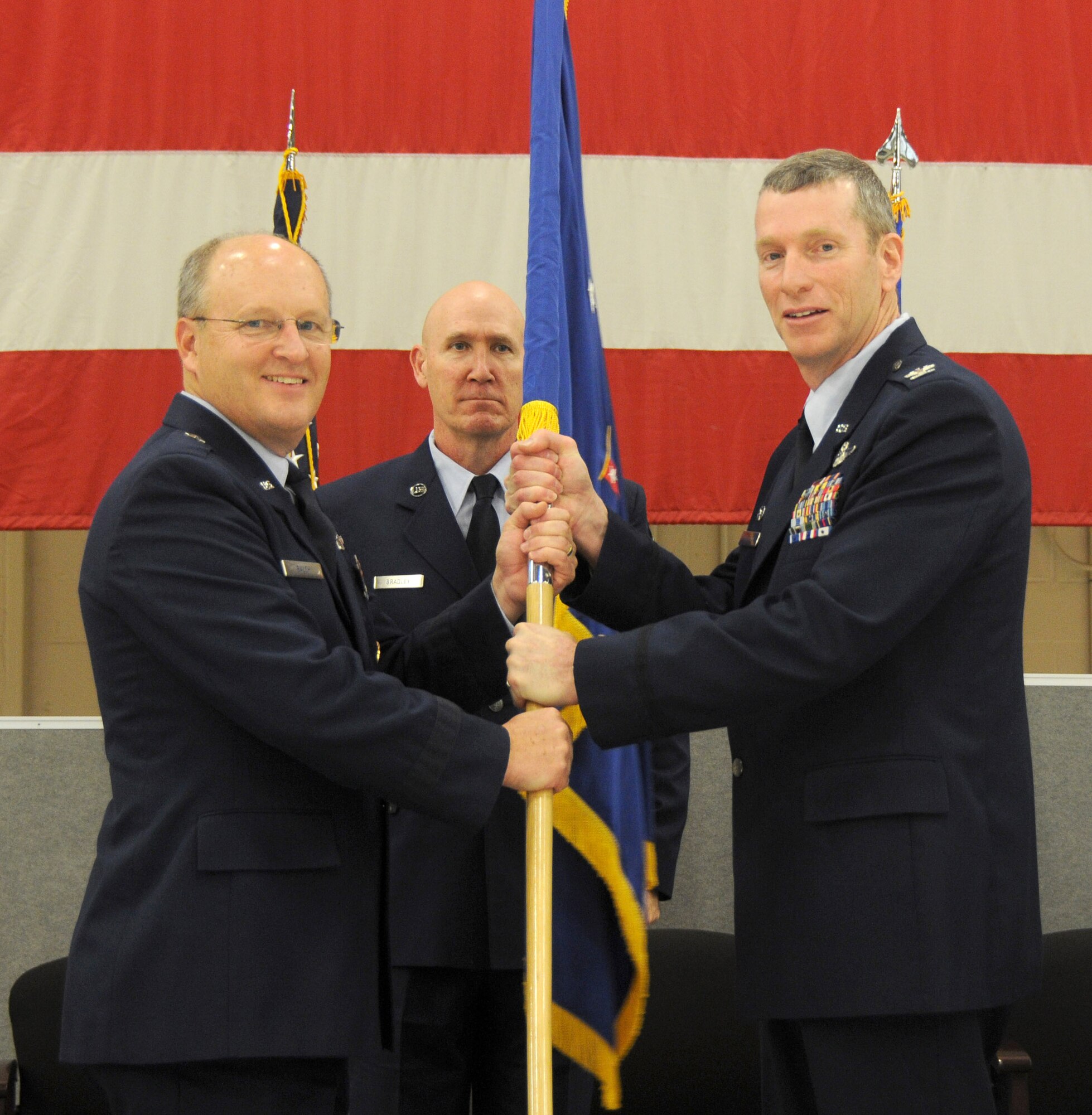 Col. Mark Anderson hands the guidon to Brig. Gen. Dwight Balch, commander of the Air National Guard, during a change of command ceremony held at Ebbing Air National Guard Base, Fort Smith, Ark., Jan. 11, 2015. Anderson relinquished command of the 188th Wing to Col. Bobbi Doorenbos, former commander of the 214th Reconnaissance Group, during the ceremony. (U.S. Air National Guard photo by Airman 1st Class Cody Martin/released) 