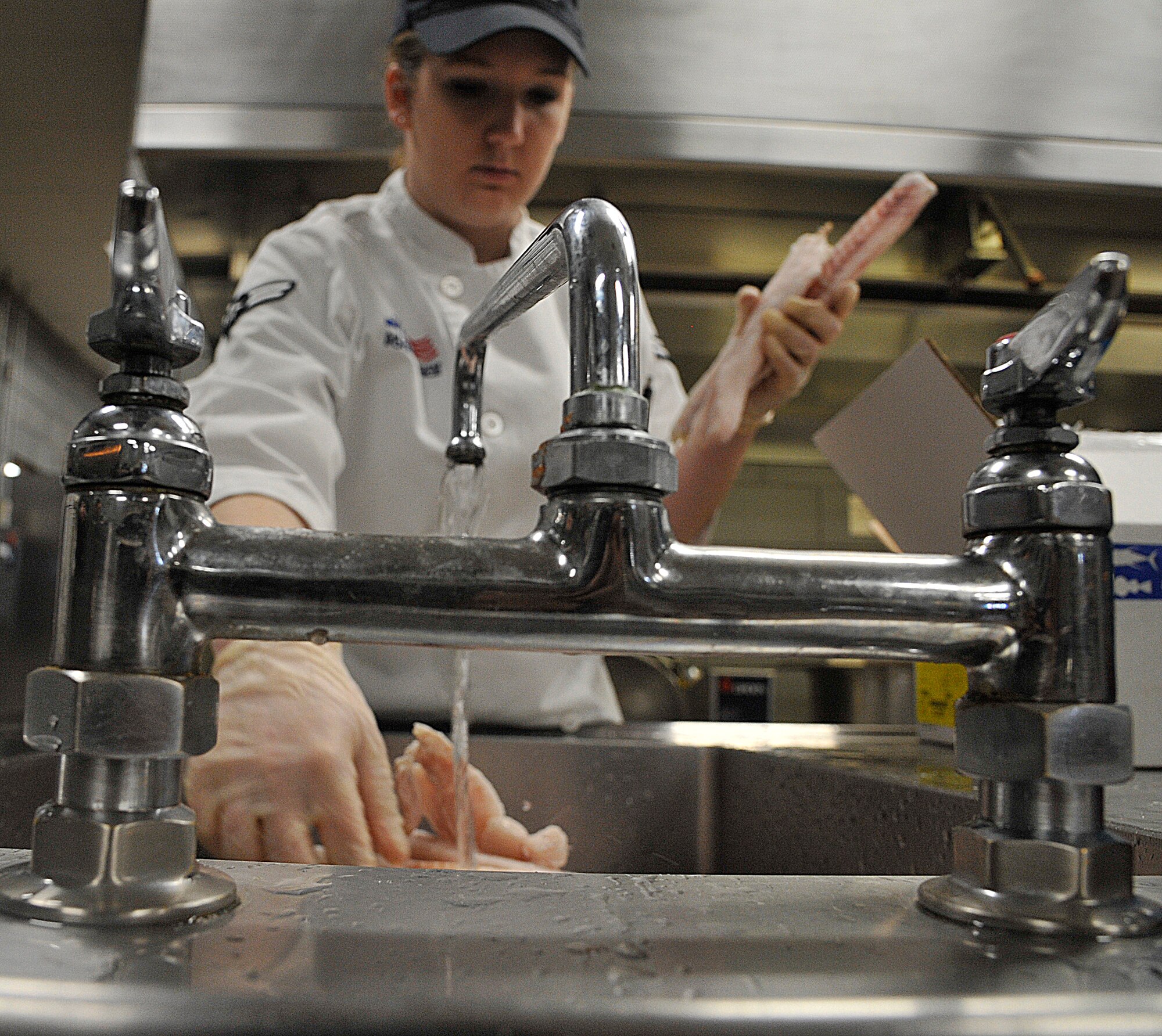 U.S. Air Force Airman 1st Class Sierra Bray, 509th Force Support Squadron food service apprentice, prepares lemon herb fish at Whiteman Air Force Base, Mo., Jan. 21, 2015. The Ozark Inn team is preparing to be evaluated for the John L. Hennessy Award inspection. Each year the Air Force presents the John L. Hennessy Award to recognize the team who best excels in food service. (U.S. Air Force photo by Senior Airman Keenan Berry/Released)