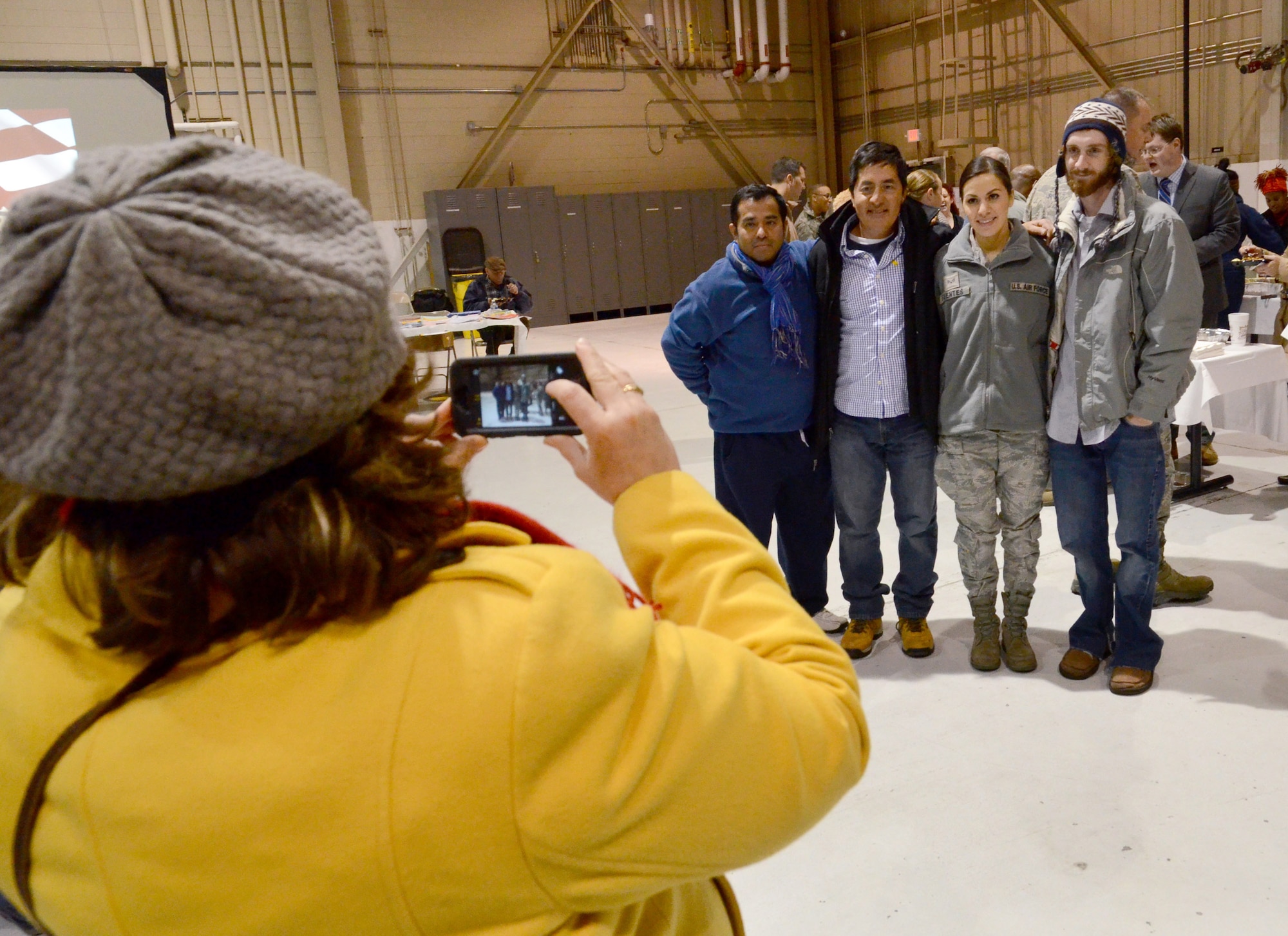 Senior Airman Marvelly Fuentes poses with family as her mom snaps a photo of them at the deployment send-off, Jan. 8, 2015 at Dobbins Air Reserve Base, Ga.  (U.S. Air Force photo/Brad Fallin)