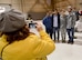 Senior Airman Marvelly Fuentes poses with family as her mom snaps a photo of them at the deployment send-off, Jan. 8, 2015 at Dobbins Air Reserve Base, Ga.  (U.S. Air Force photo/Brad Fallin)