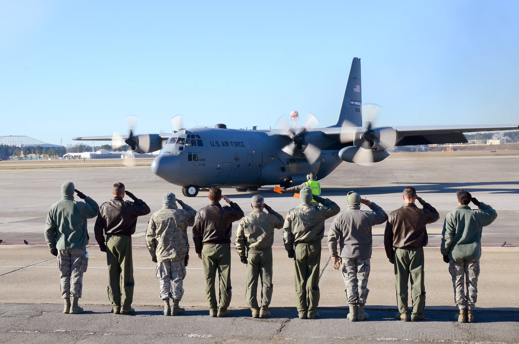 Dobbins Air Reserve Base leadership salutes the aircrew as the 94th Airlift Wing Hercules begins to taxi out for takeoff to Southwest Asia, at Dobbins Air Reserve Base, Ga., Jan. 8, 2015. (U.S. Air Force photo/Brad Fallin)