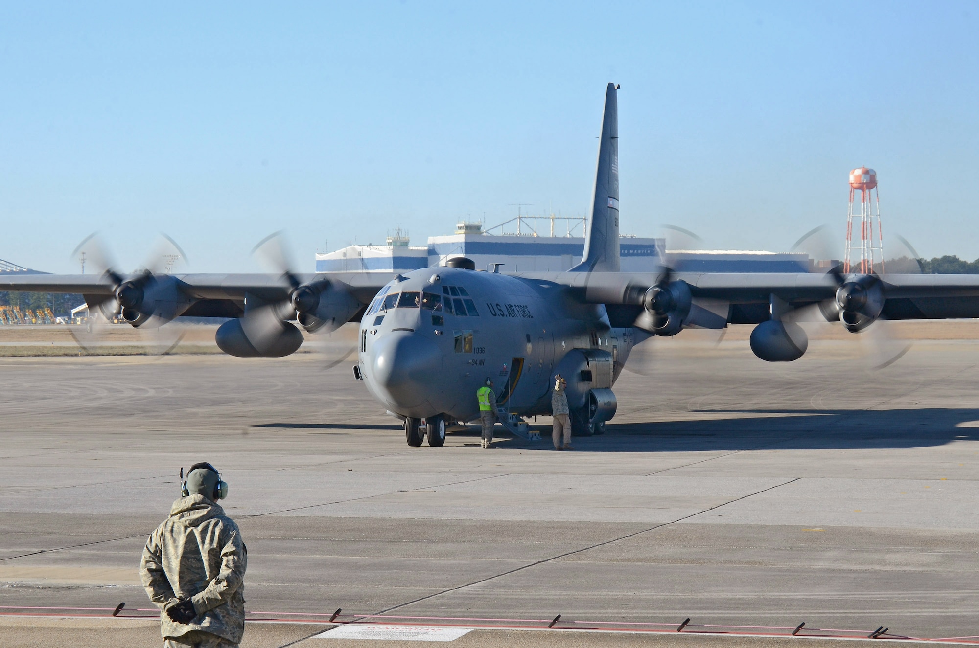 The 700th Airlift Squadron loadmaster prepares to board the 94th Airlift Wing C-130H3 after all engines are running at Dobbins Air Reserve Base, Ga., Jan. 8, 2015. The aircraft and crew are leaving for deployment to Southwest Asia.  (U.S. Air Force photo/Brad Fallin)