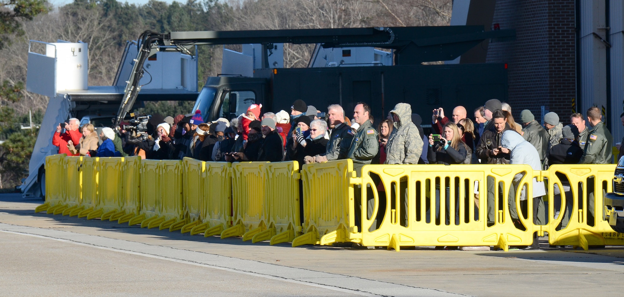 Family and friends assemble to watch 94th Airlift Wing personnel depart on their deployment to Southwest Asia, at Dobbins Air Reserve Base, Ga., Jan. 8, 2015. (U.S. Air Force photo/Brad Fallin)