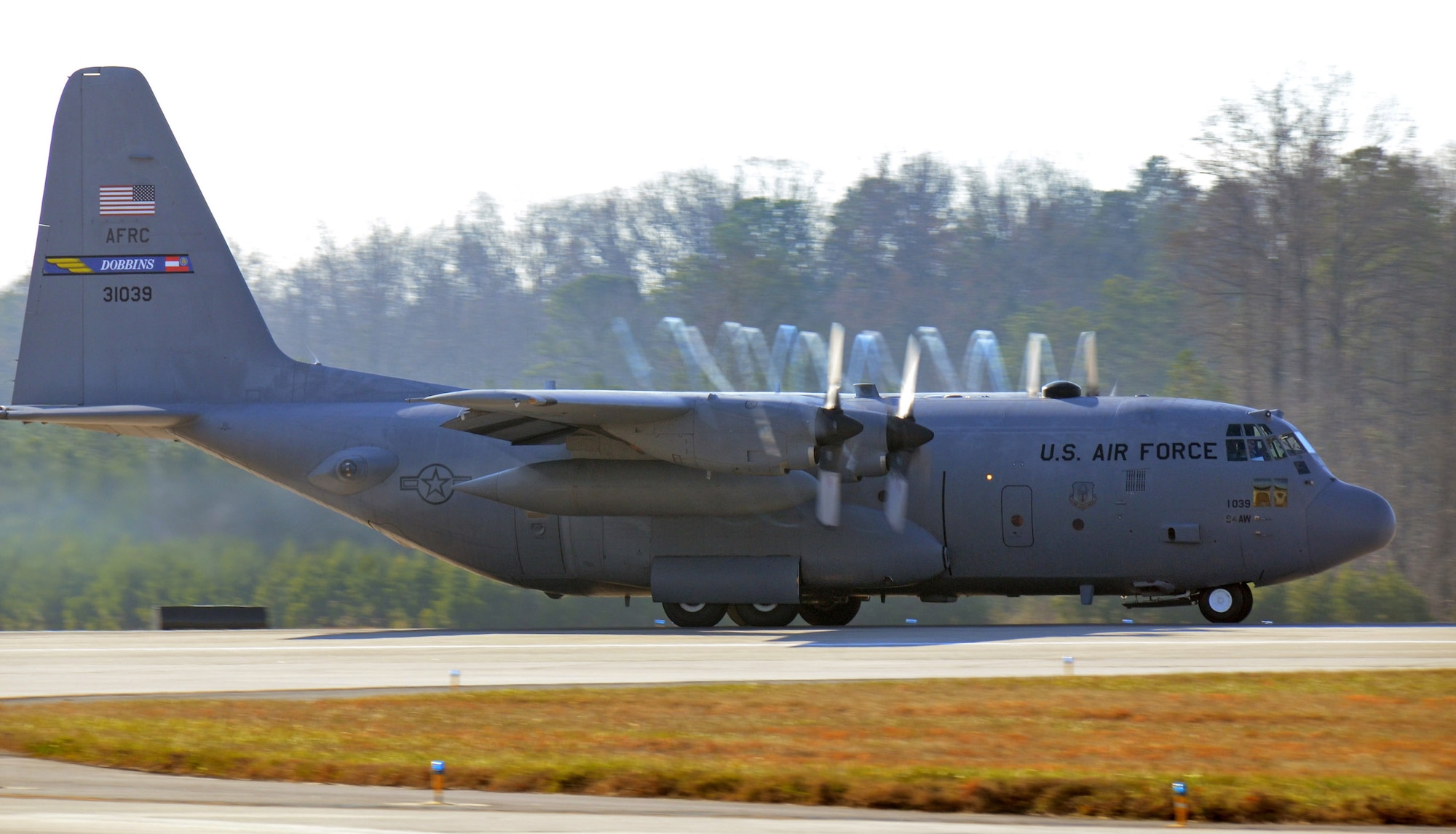 The 94th Airlift Wing C-130H3 beats the moisture out of the air as it accelerates down the Dobbins runway on its way to Southwest Asia; Dobbins Air Reserve Base, Ga., Jan. 5, 2015. (U.S. Air Force photo/Brad Fallin)