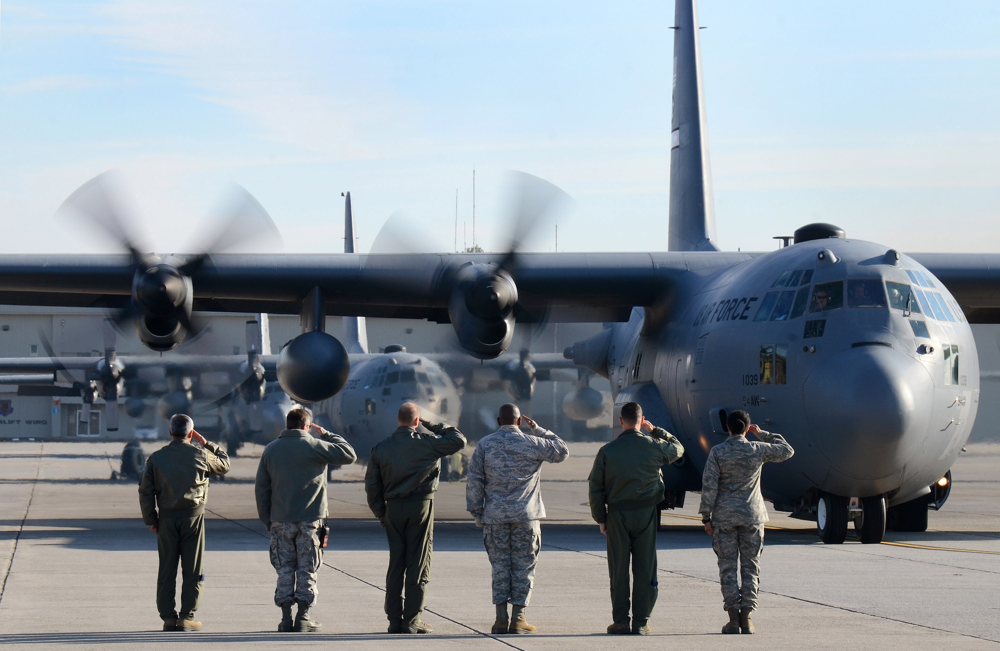 Dobbins Air Reserve Base leadership salutes the aircrew as the 94th Airlift Wing Hercules begins to taxi out for takeoff to Southwest Asia, Jan. 5, 2015. (U.S. Air Force photo/Brad Fallin)