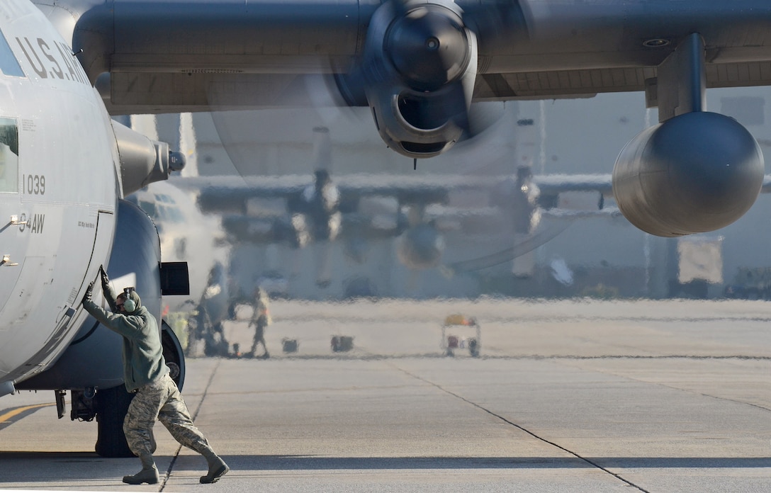 C-130H Crew Chief Senior Airman David Yancey ensures the forward doorway is closed as the 94th Airlift Wing Hercules is nearly ready to deploy to Southwest Asia, Jan. 5, 2015. (U.S. Air Force photo/Brad Fallin)