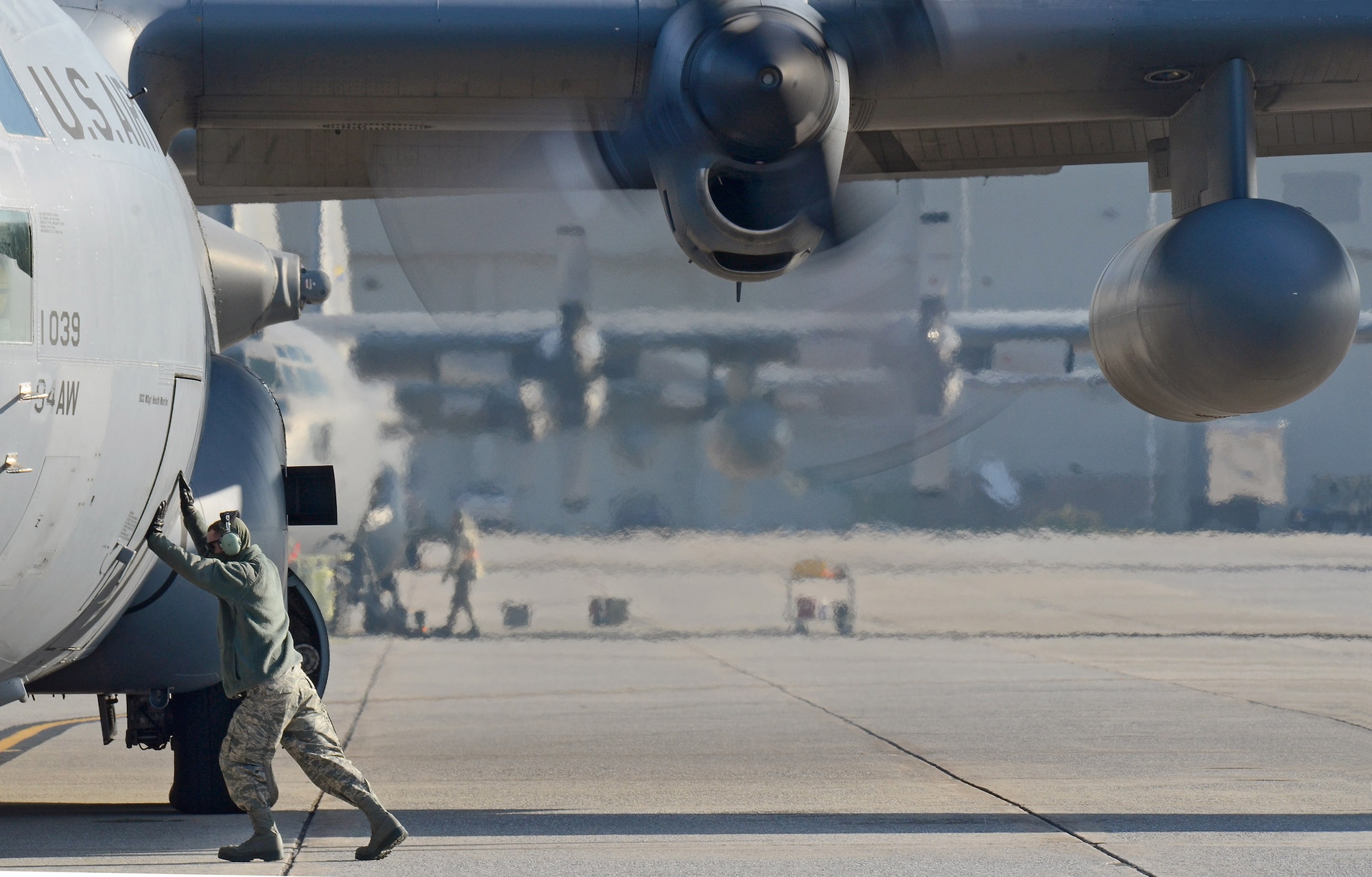 C-130H Crew Chief Senior Airman David Yancey ensures the forward doorway is closed as the 94th Airlift Wing Hercules is nearly ready to deploy to Southwest Asia, Jan. 5, 2015. (U.S. Air Force photo/Brad Fallin)